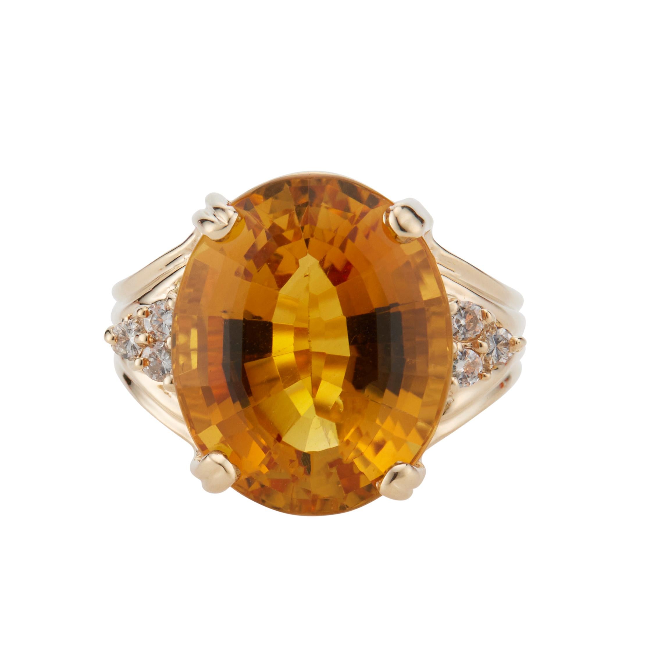 Orange citrine and diamond ring. 14.17ct oval orange/yellow citrine center stone in a 14k yellow gold cocktail setting with 6 round brilliant cut accent diamonds.  

1 oval yellowish orange citrine, VS approx. 14.17cts
6 round brilliant cut
