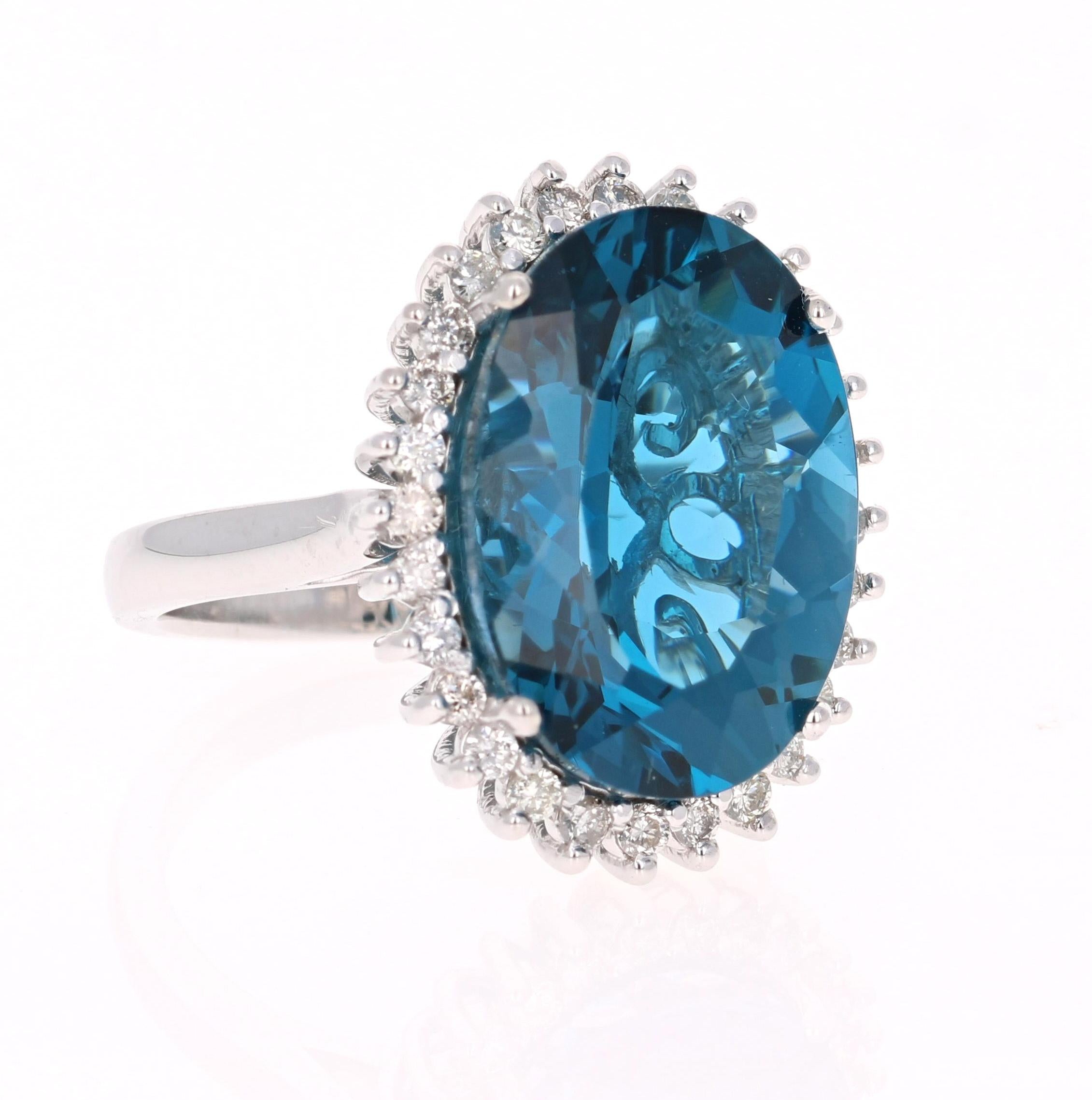 This beautiful Oval cut Blue Topaz and Diamond ring has a stunningly large Blue Topaz that weighs 13.62 Carats. It is surrounded by 28 Round Cut Diamonds that weigh 0.57 Carats. The total carat weight of the ring is 14.19 Carats. 
The setting is