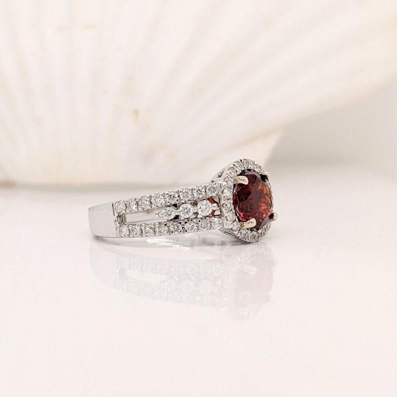This beautiful spessartine Garnet has a deep red color accentuated by the diamond halo and pave shank set in 14k white Gold. A unique gemstone ring that would be a beautiful engagement ring or statement piece. A great January birthstone