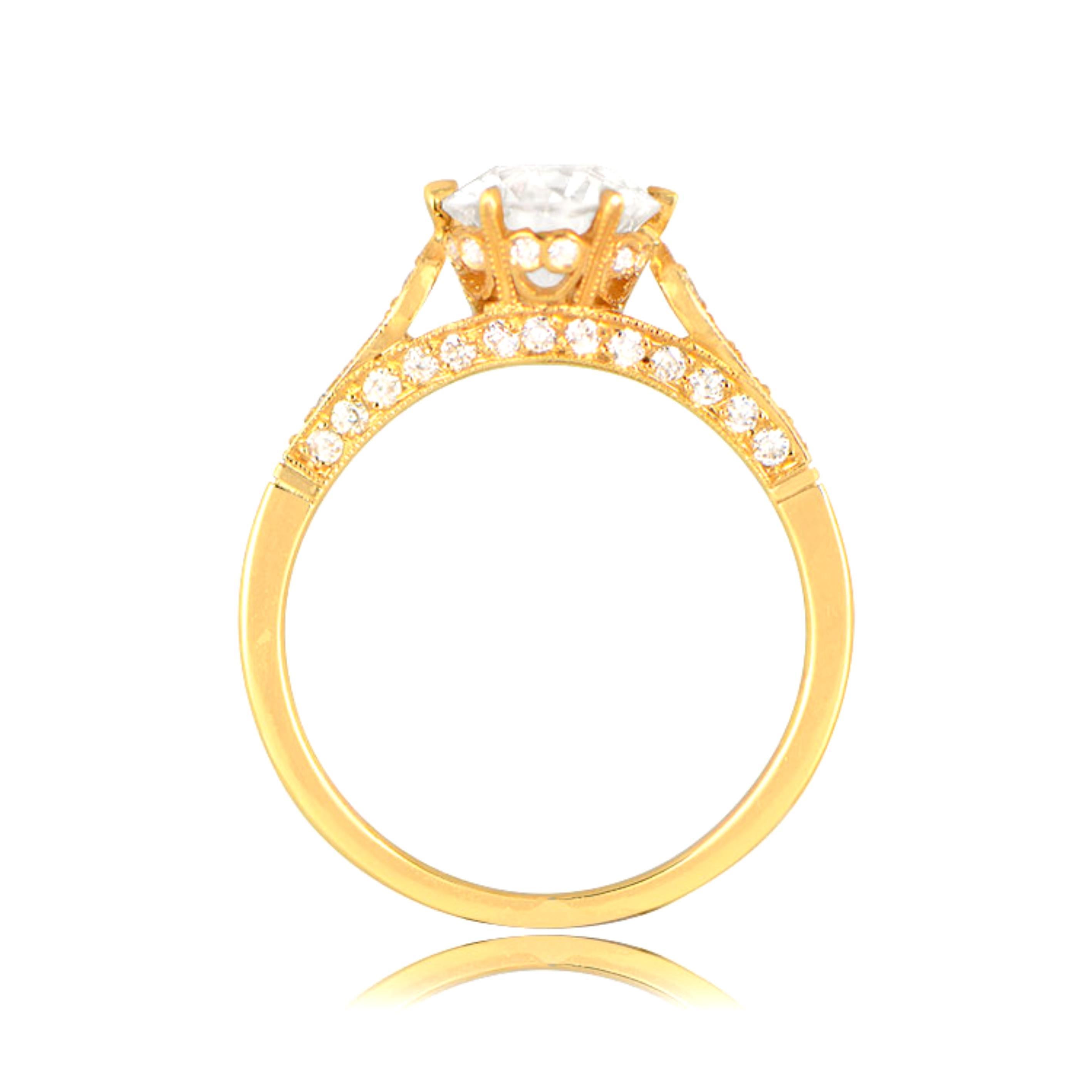 This crown-style diamond solitaire engagement ring features a 1.41 carat old European cut diamond, K color and VS1 clarity, and is handcrafted in 18k yellow gold. The ring is decorated with fine milgrain and smaller old European cut diamonds set on