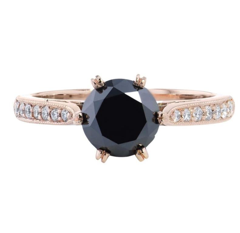 Evoke mystery and intrigue with this stunning, handmade H and H black diamond and rose gold engagement ring. 18 karat rose gold embraces 0.17 carat of pave set diamonds streaming down the shank and around the basket(G/H/I/VS). At center, a 1.42