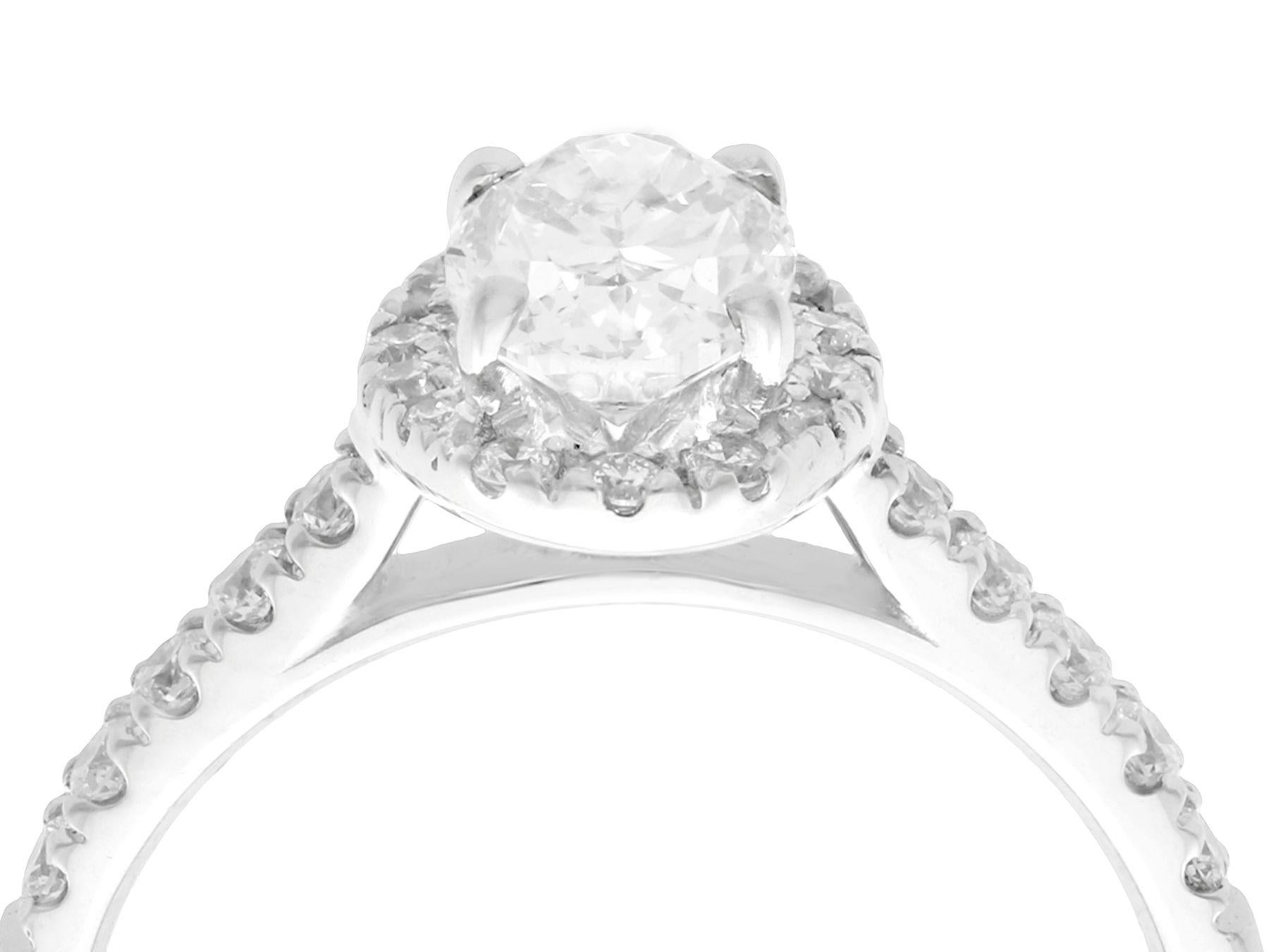 A stunning, fine and impressive contemporary 1.42 carat diamond and 18 karat white gold halo ring; part of our diverse diamond jewelry and estate jewelry collections.

This stunning, fine and impressive oval cut diamond ring with halo has been