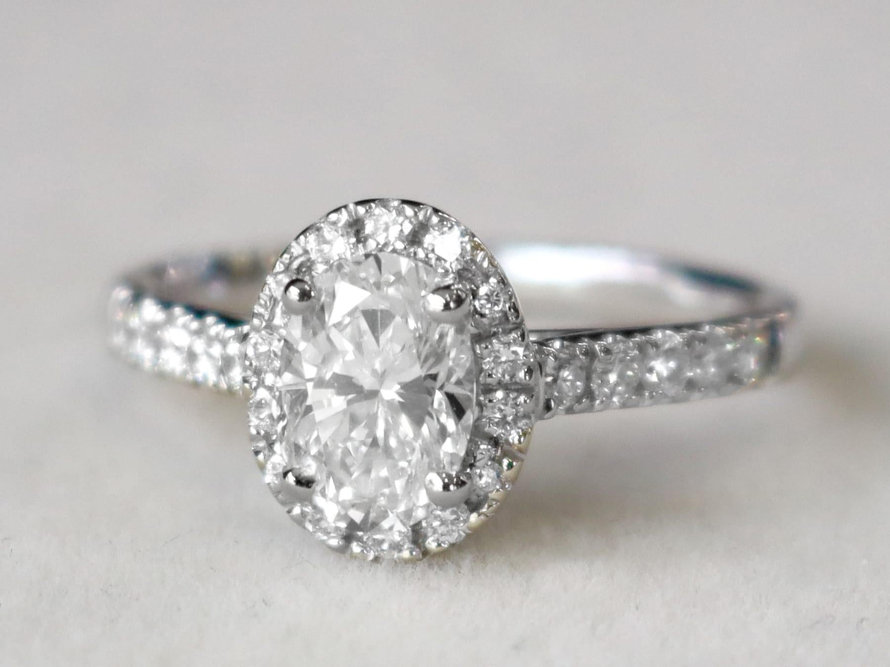 A stunning, fine and impressive contemporary 1.42 carat diamond and 18 karat white gold halo ring; part of our diverse diamond jewelry and estate jewelry collections.

This stunning, fine and impressive oval cut diamond ring with halo has been