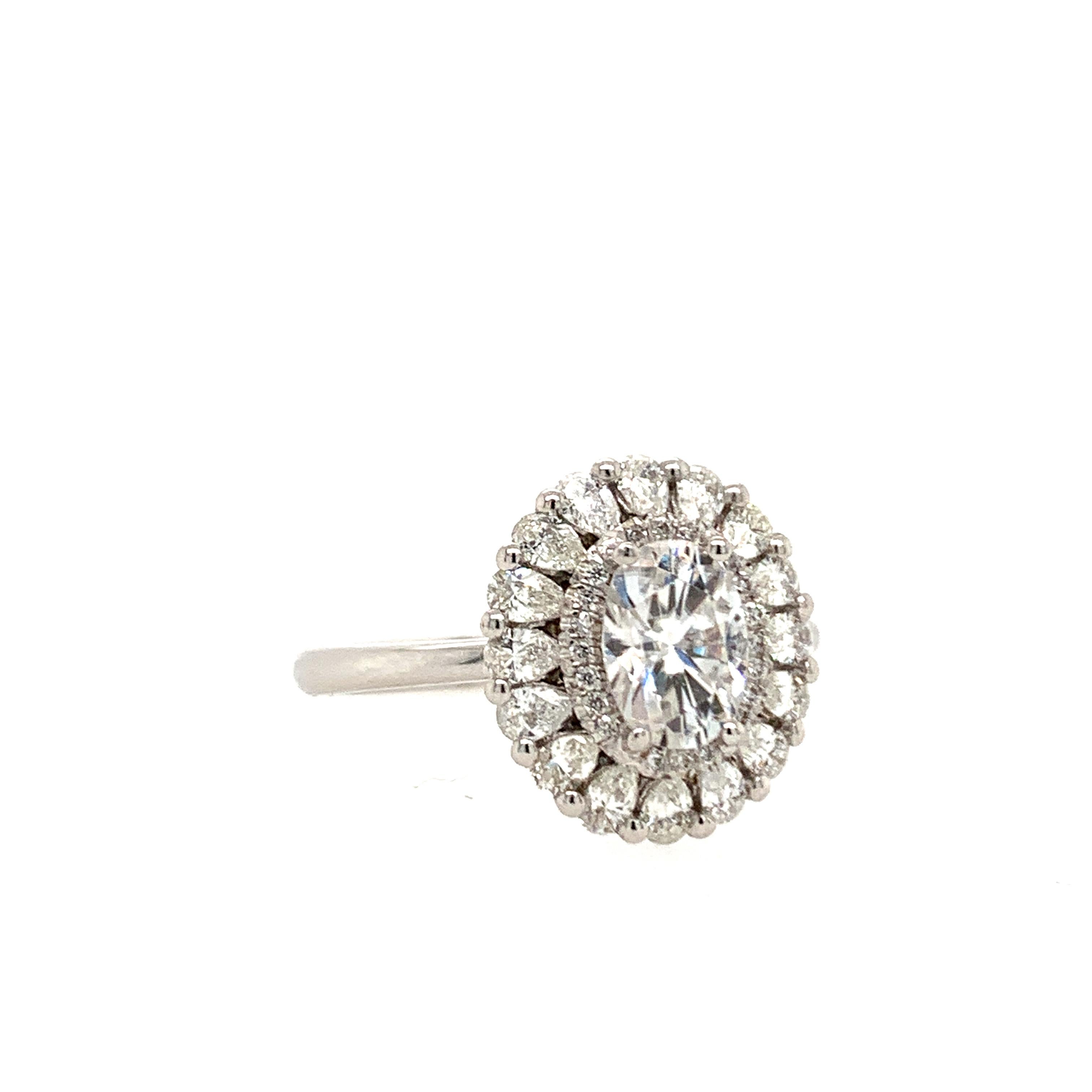 This beautiful ring flaunts a 0.80 carat oval-cut natural white diamond surrounded by a diamond halo and set atop a bed of pear-shaped white diamonds.

Set in 14K white gold.

Center stone: Natural white diamond - 0.80 carat, color G, clarity SI1