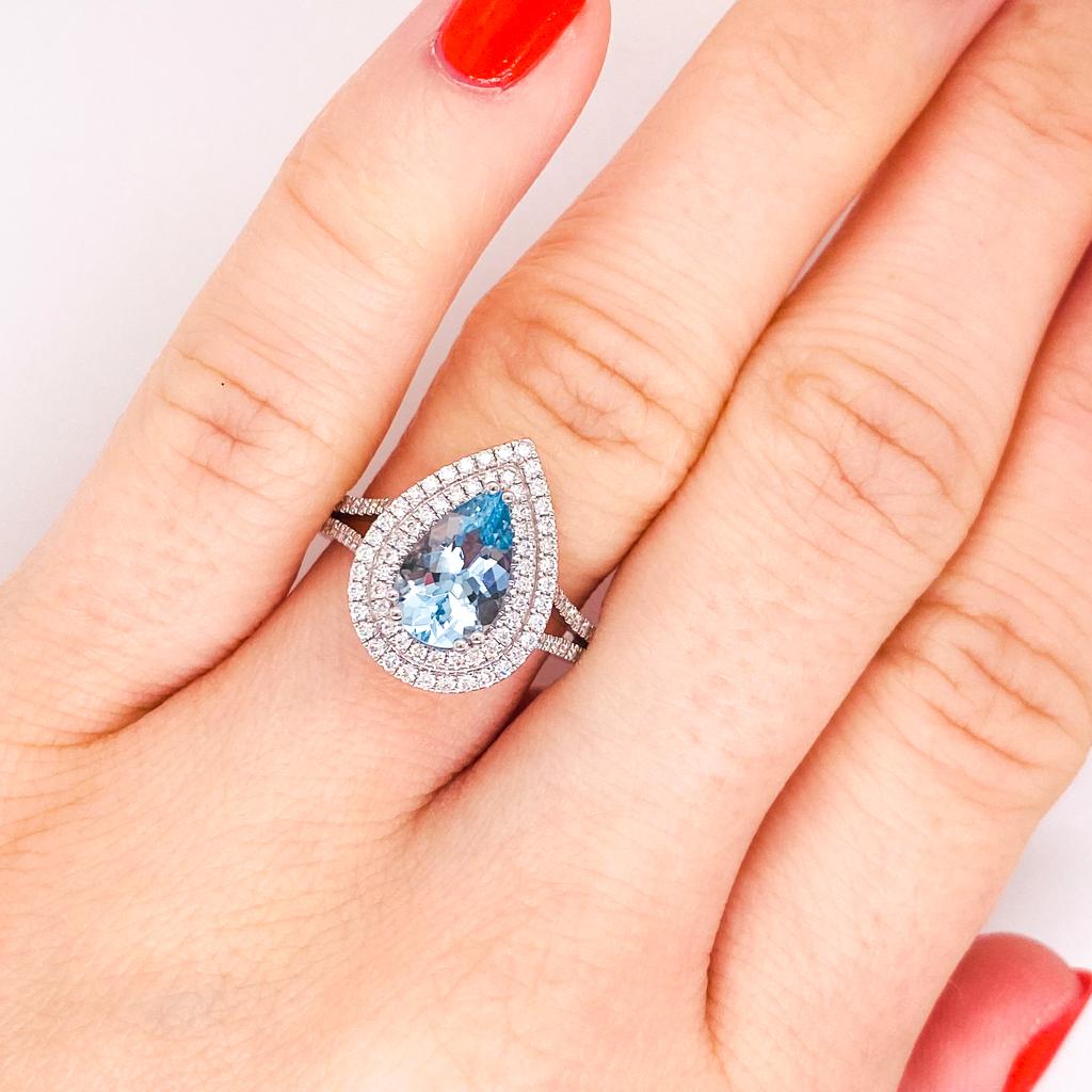 This gorgeous aquamarine and diamond ring is a fabulous piece to wear! The aquamarine is 1.42 carats with a fabulous double halo of diamonds surrounding the pear and adding to the sparkle! The aquamarine has a gorgeous sky blue color and reflects