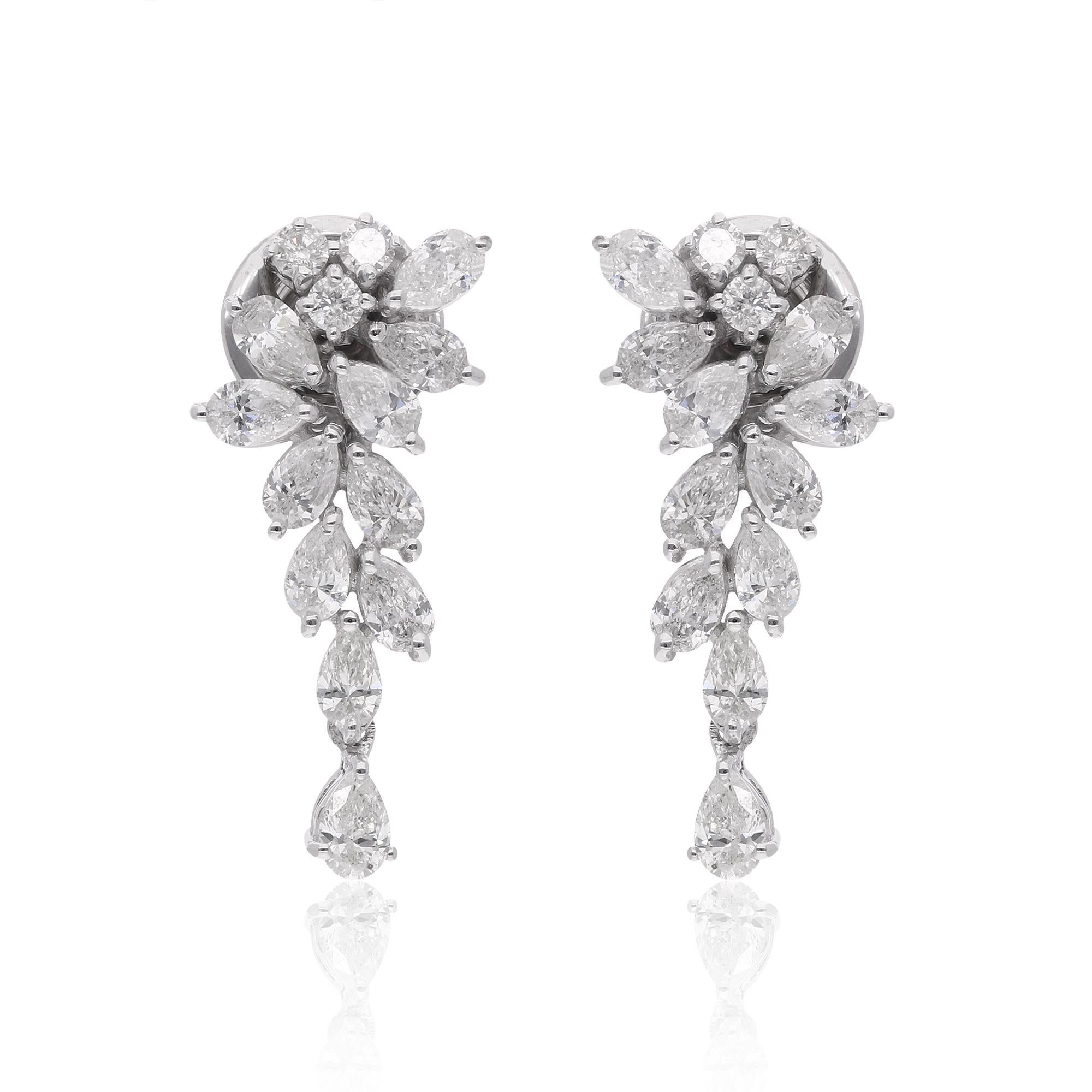 These dangle earrings are meticulously crafted, with each diamond precisely set to showcase its beauty. The design allows the earrings to gracefully sway with your every movement, capturing attention and adding a touch of glamour to any ensemble.