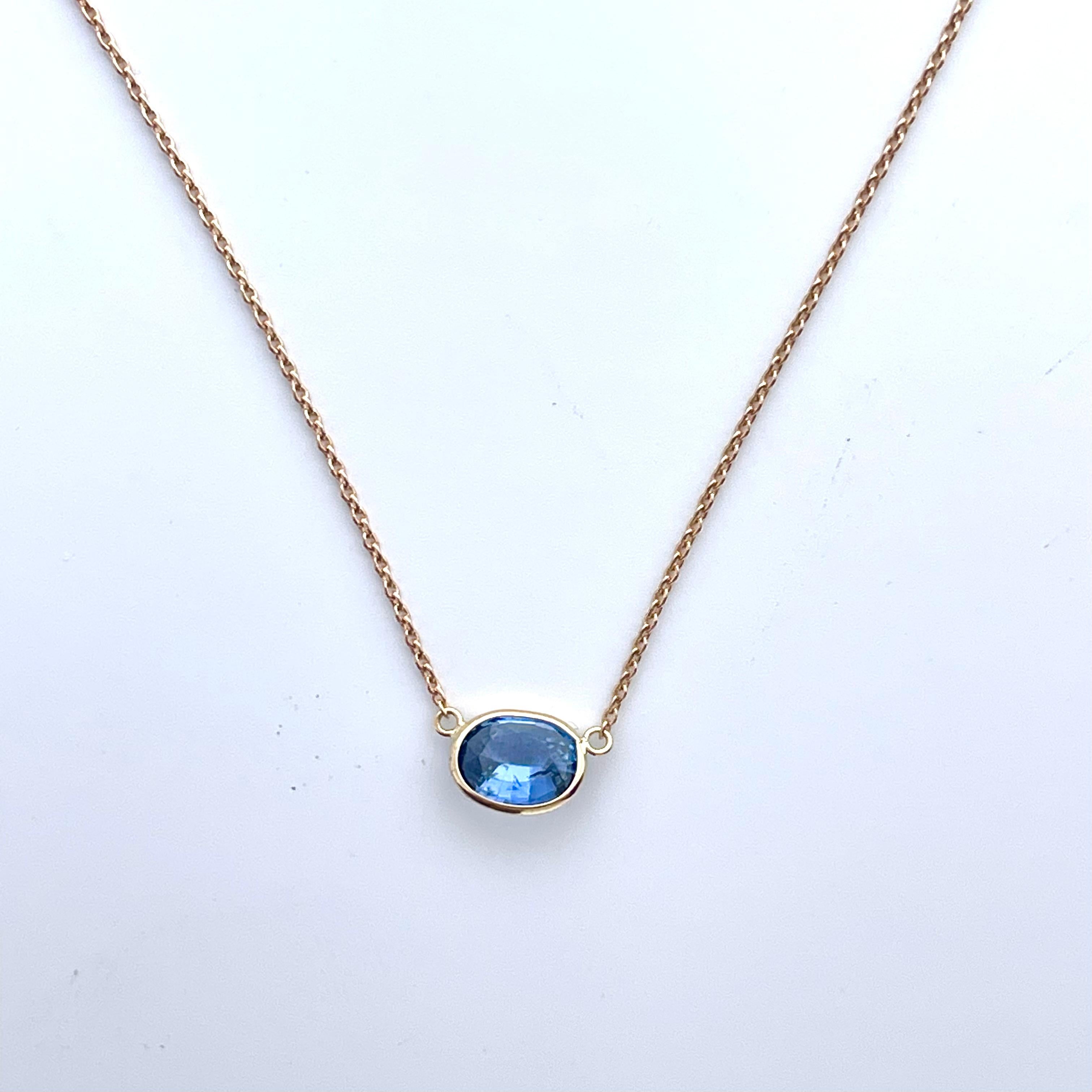 A fashion necklace made of 14k rose gold with a main stone of an oval-cut blue sapphire weighing 1.42 carats would be a stunning and elegant choice. Blue sapphires are renowned for their captivating and deep blue color, and the oval cut adds a
