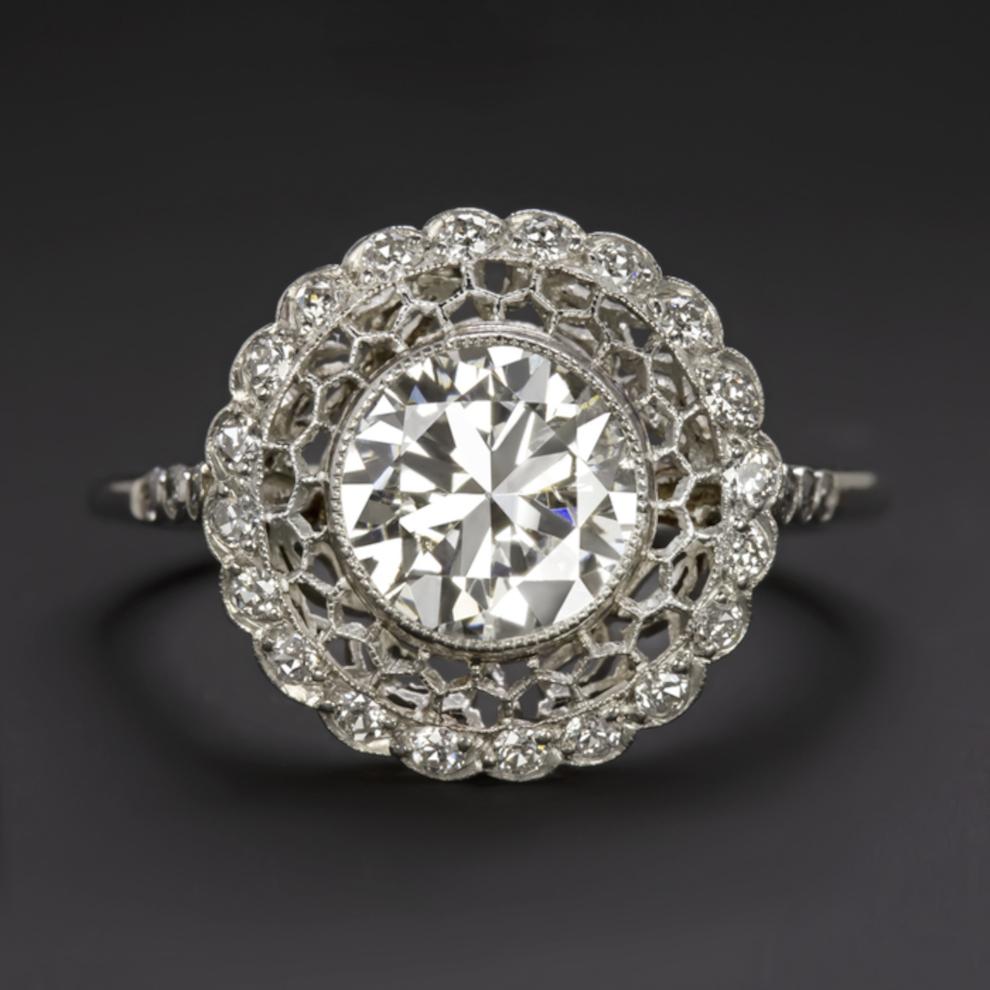 Ring featuring a 1.42 ct phenomenal old European cut center diamond set in a diamond encrusted platinum setting.
The central diamond is an antique piece, it is a true Old European Cut diamond, while the ring has recently been handcrafted by master