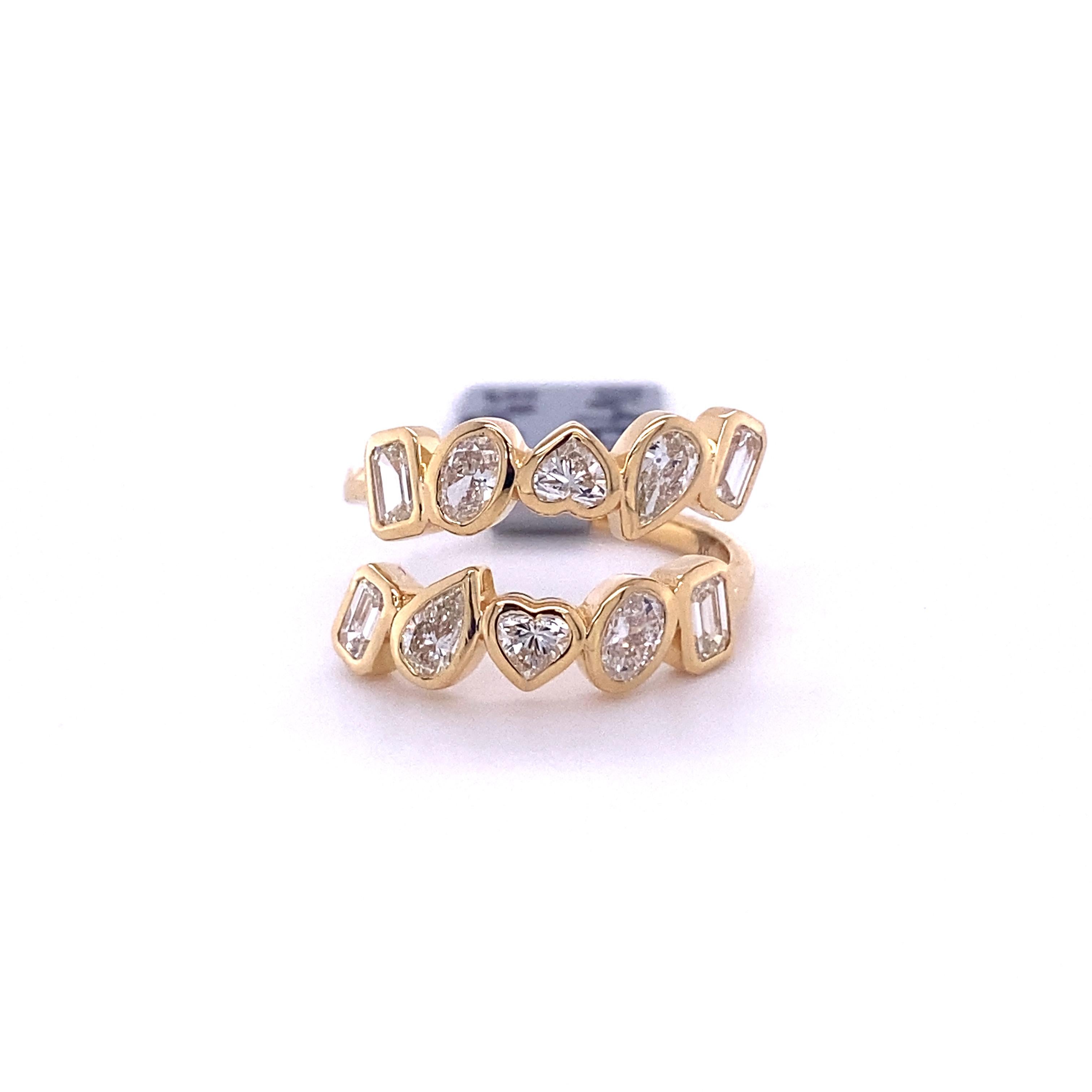 Multishape diamond eternity band with 10 hand set diamonds in varying diamond shapes.

1.42 carats of white pear, oval, heart and emerald cut diamonds set in 18k yellow gold.

