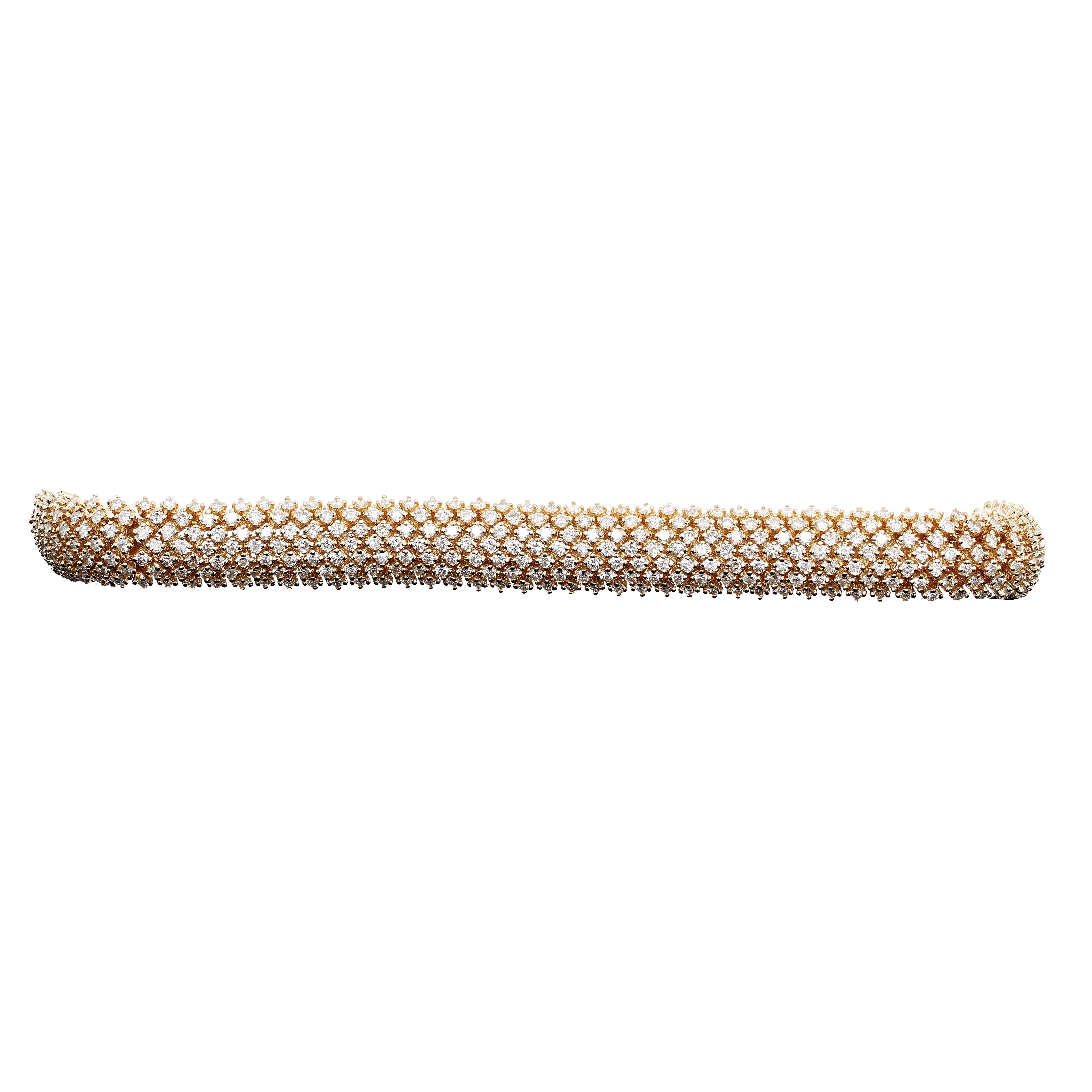 14 karat yellow gold diamond tennis bracelet. The bracelet has great movement and fits comfortably on your wrist. There are 7 rows of round brilliant white diamonds with an estimated diamond carat weight of 14.20 carats.

The bracelet measures 7.25