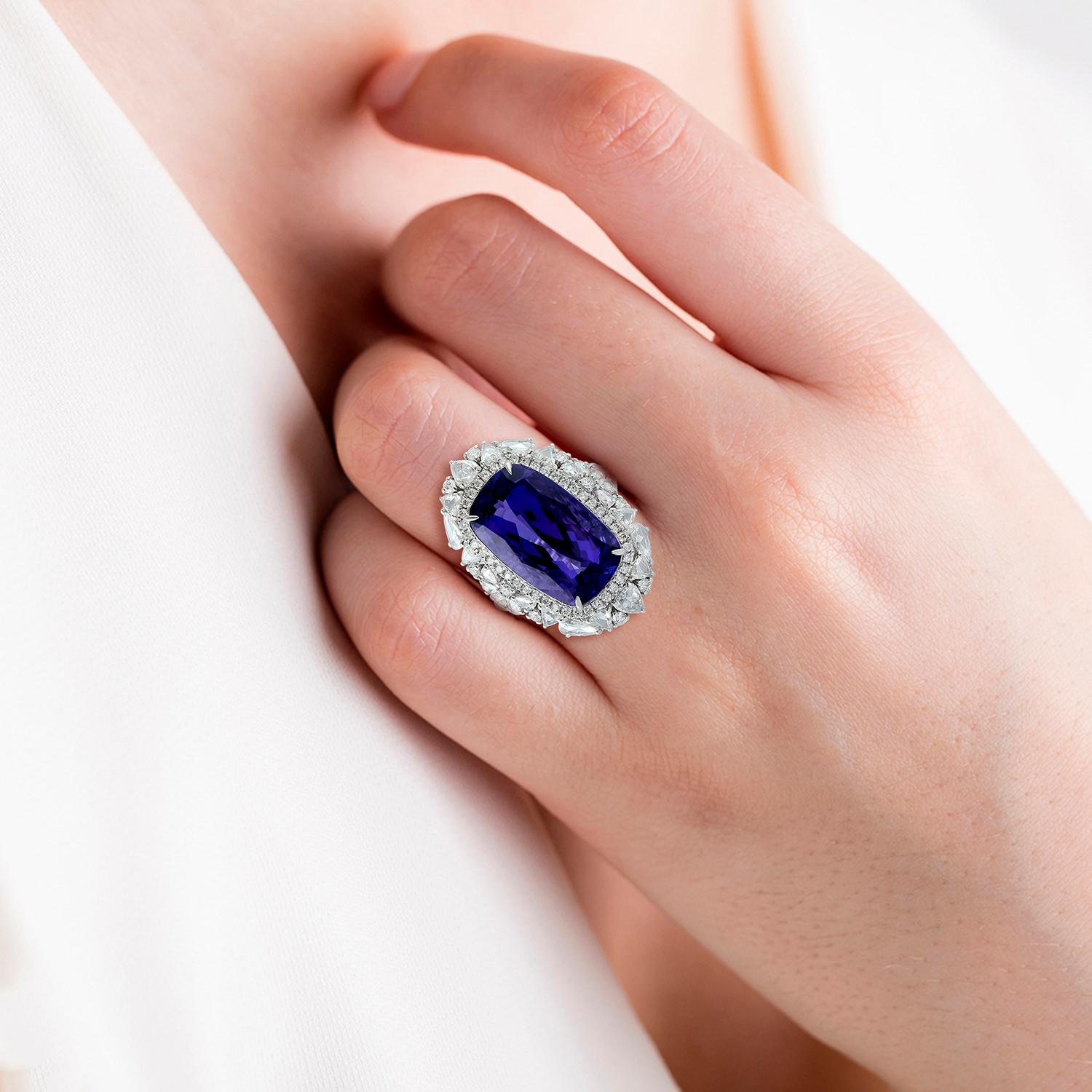 This stunning ring has been meticulously crafted from 18-karat gold. It is hand set with 14.21 carats tanzanite and illuminated with 2.1 carats of sparkling diamonds. 

The ring is a size 7 and may be resized to larger or smaller upon request.