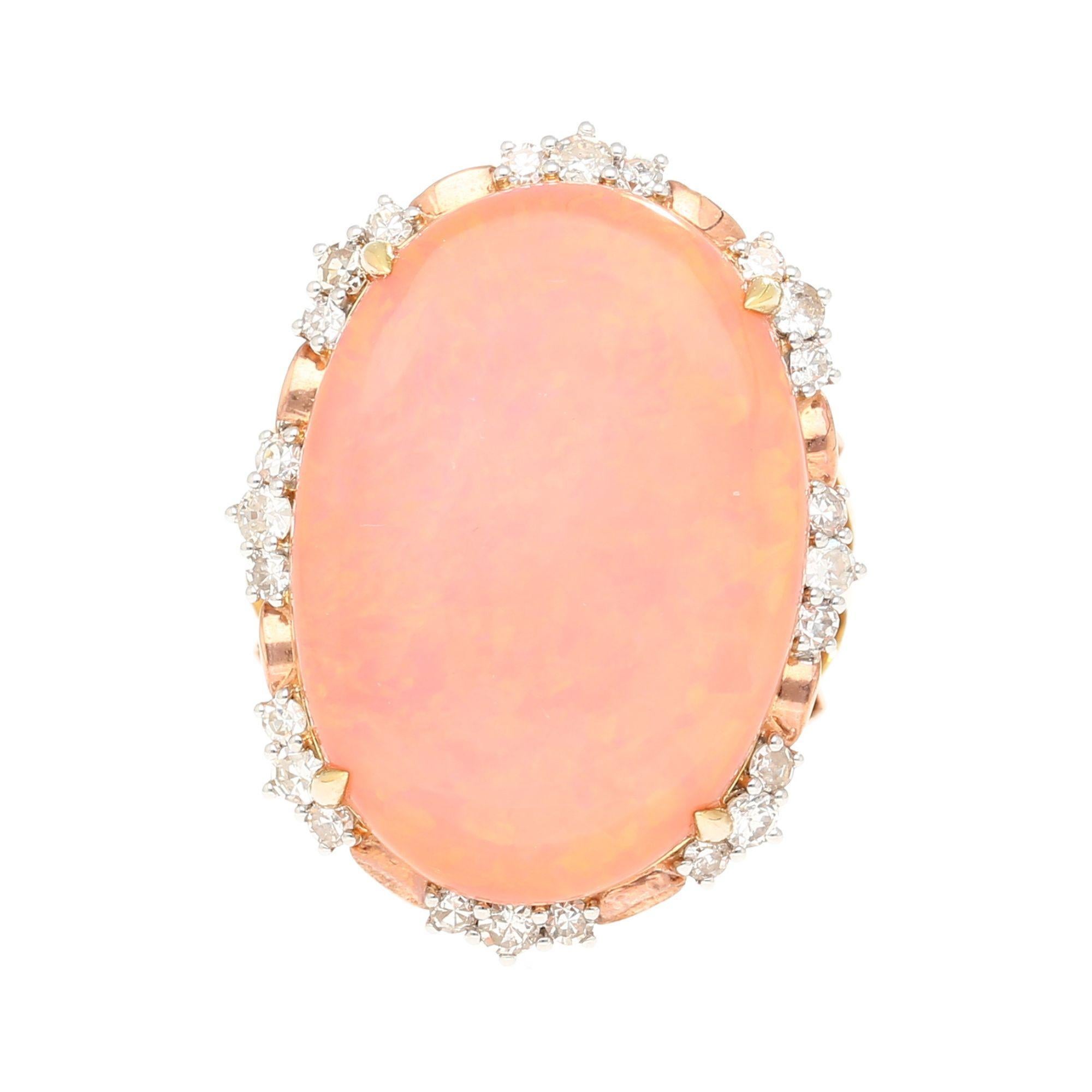 This 14.24 carat pink opal is framed in a sparkling 0.66 carat diamond halo and set in an intricately sculpted 18K yellow and rose gold cocktail ring. The floral split shank design and bold structure create an elegant yet standout look. Size 7, not