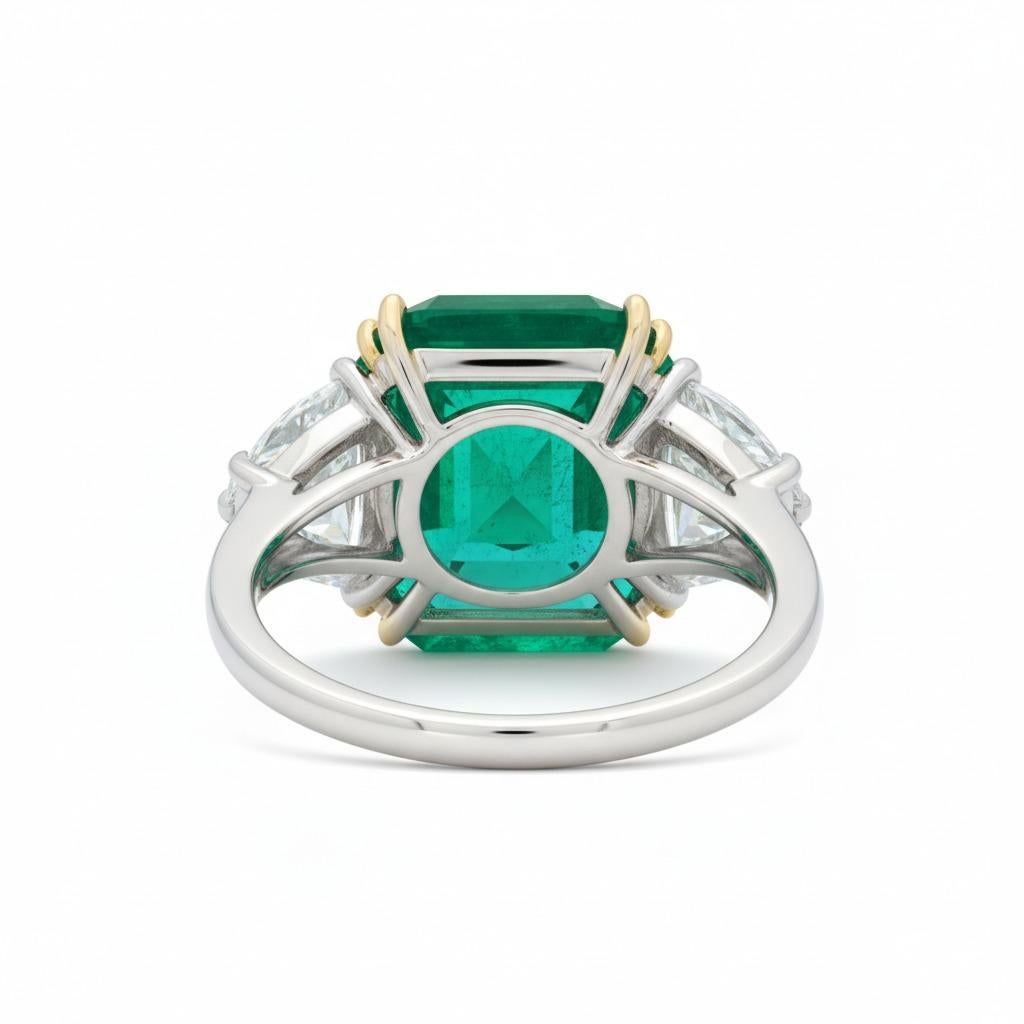 14.25 Carat Zambian Emerald & Half Moon Diamond Platinum and 18K Yellow Gold Ring

An exceptional statement ring featuring a Natural Zambian Emerald weighing 14.25 carats, certified by ICA GemLab, described as Intense Green in color, transparent,