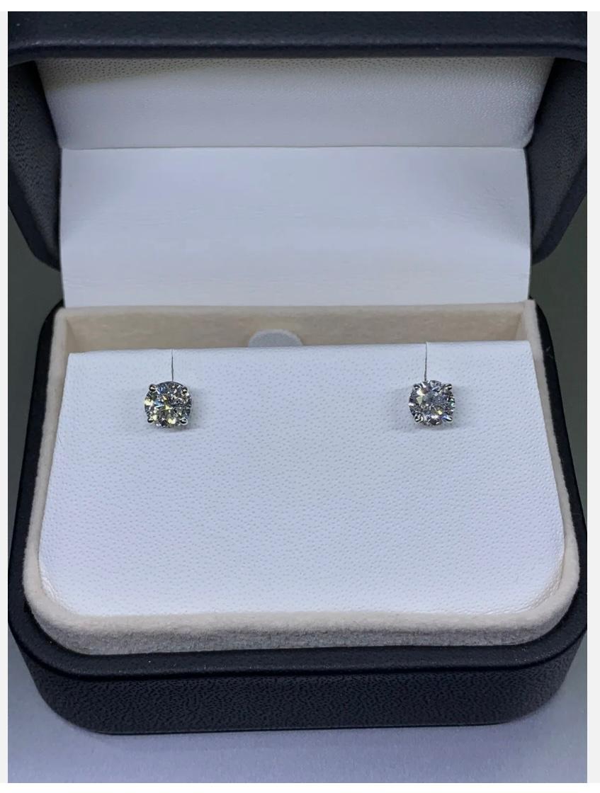 Add a touch of elegance to your look with these stunning 1.42ct Diamond certified solitaire studs earrings. Made from 18ct white gold, these earrings boast a beautiful round shape and a fancy coloured diamond intensity. The earrings feature a