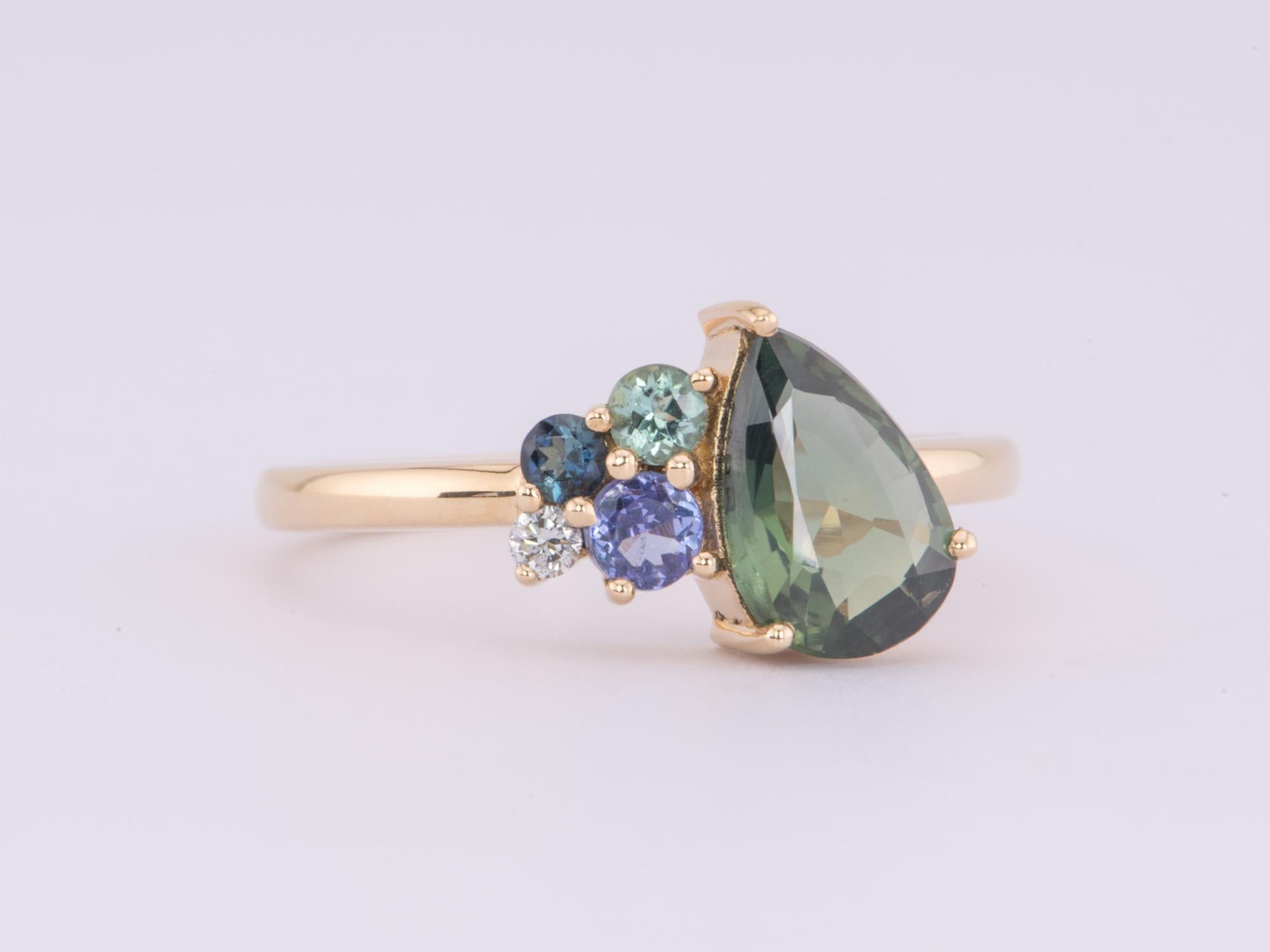   Declare your love with this uniquely asymmetrical 1.42ct Nigerian Teal Sapphire and Diamond Cluster Ring crafted from 14K gold! Its charming and sparkling cluster design will take their breath away! Will you say yes?

♥ This ring measures 11.7mm