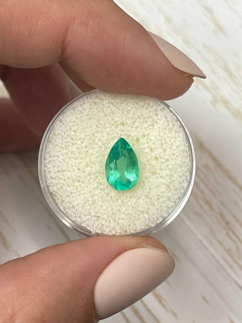 Stone: Emerald
Weight: 1.42-carats
Shape: Pear Cut
Clarity: Transparent
Luster: Very Good
Color: Medium Yellowish Green
Measurements: 9.69mm x 6.23mm x 4.52mm
Geographic Origin: Colombia
Treatment: Natural, Oiling

Comments: Due to their growth