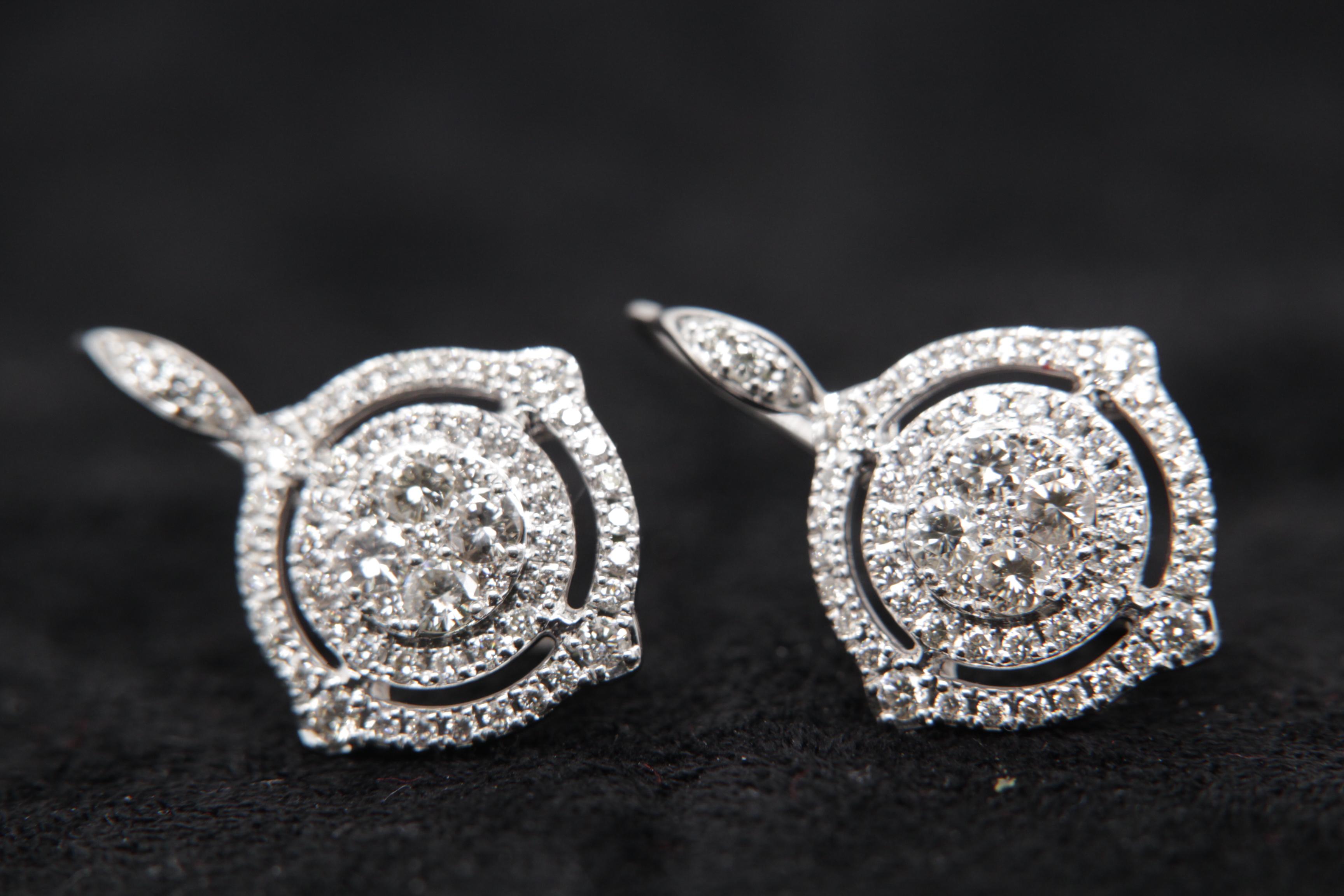 A brand new diamond earring in 18 karat gold. The total diamond weight is 1.43 carat and total earring weight is 5.31 grams.