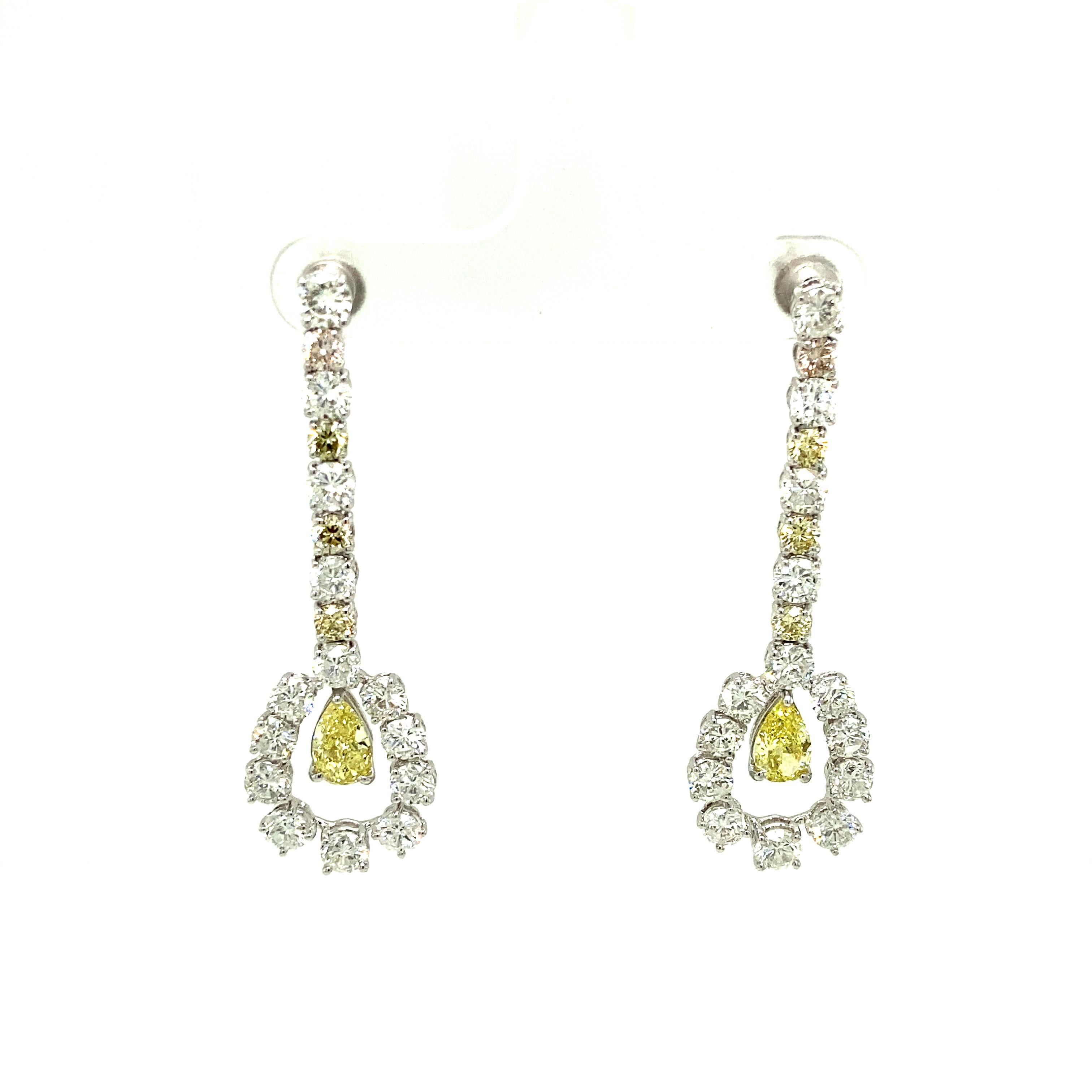 1.43 Carat GIA Certified Fancy Intense Yellow Diamonds and Diamond Gold Earrings:

A stunning pair of earrings, it features two elegant pear-shaped GIA certified fancy intense yellow and fancy yellow diamonds weighing 1.43 carat, surrounded by an
