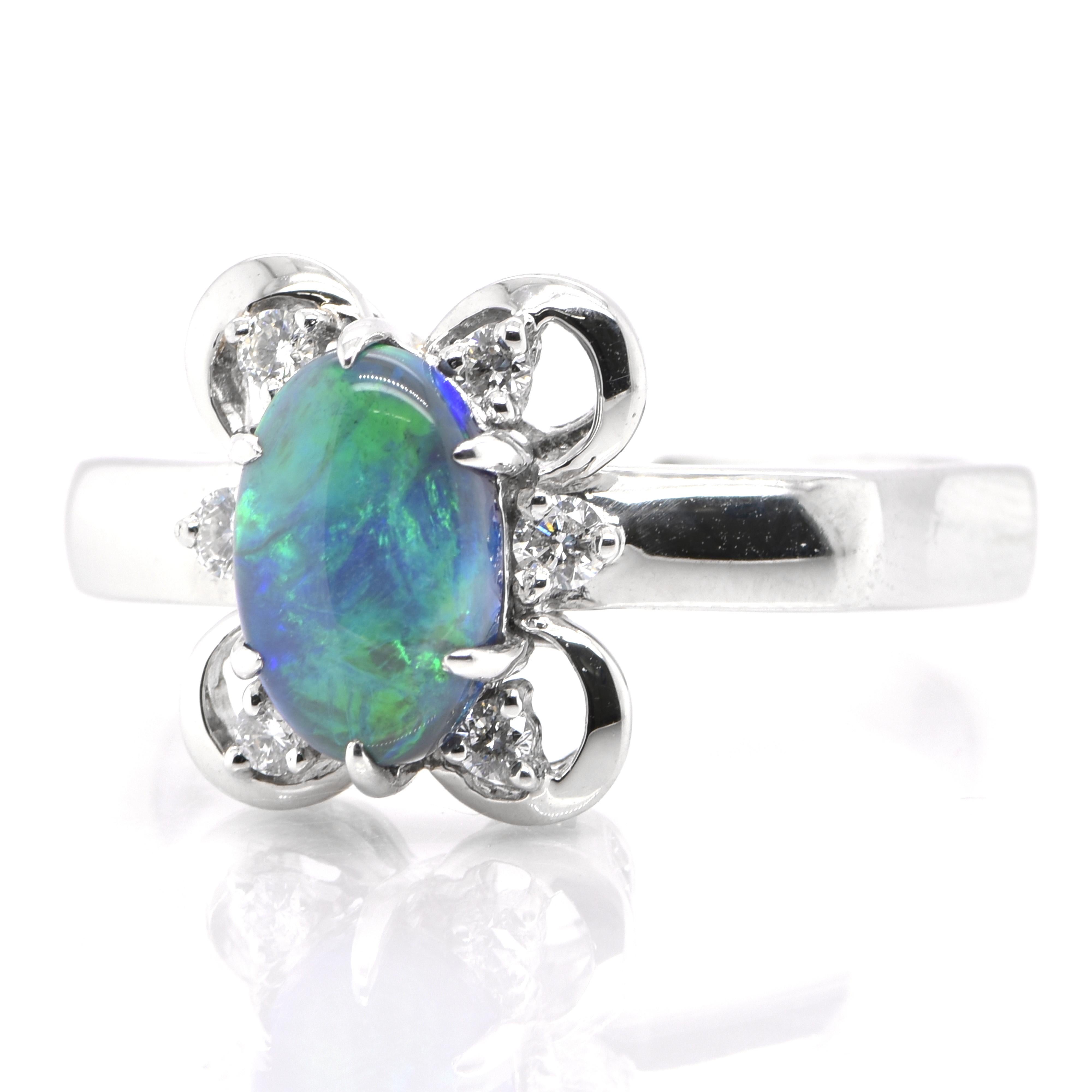 A beautiful Cocktail Ring featuring a 1.43 Carat, Natural, Australian Black Opal and 0.20 Carats of Diamond Accents set in Platinum. The Opal displays very good play of color! Opals are known for exhibiting flashes of rainbow colors known as 