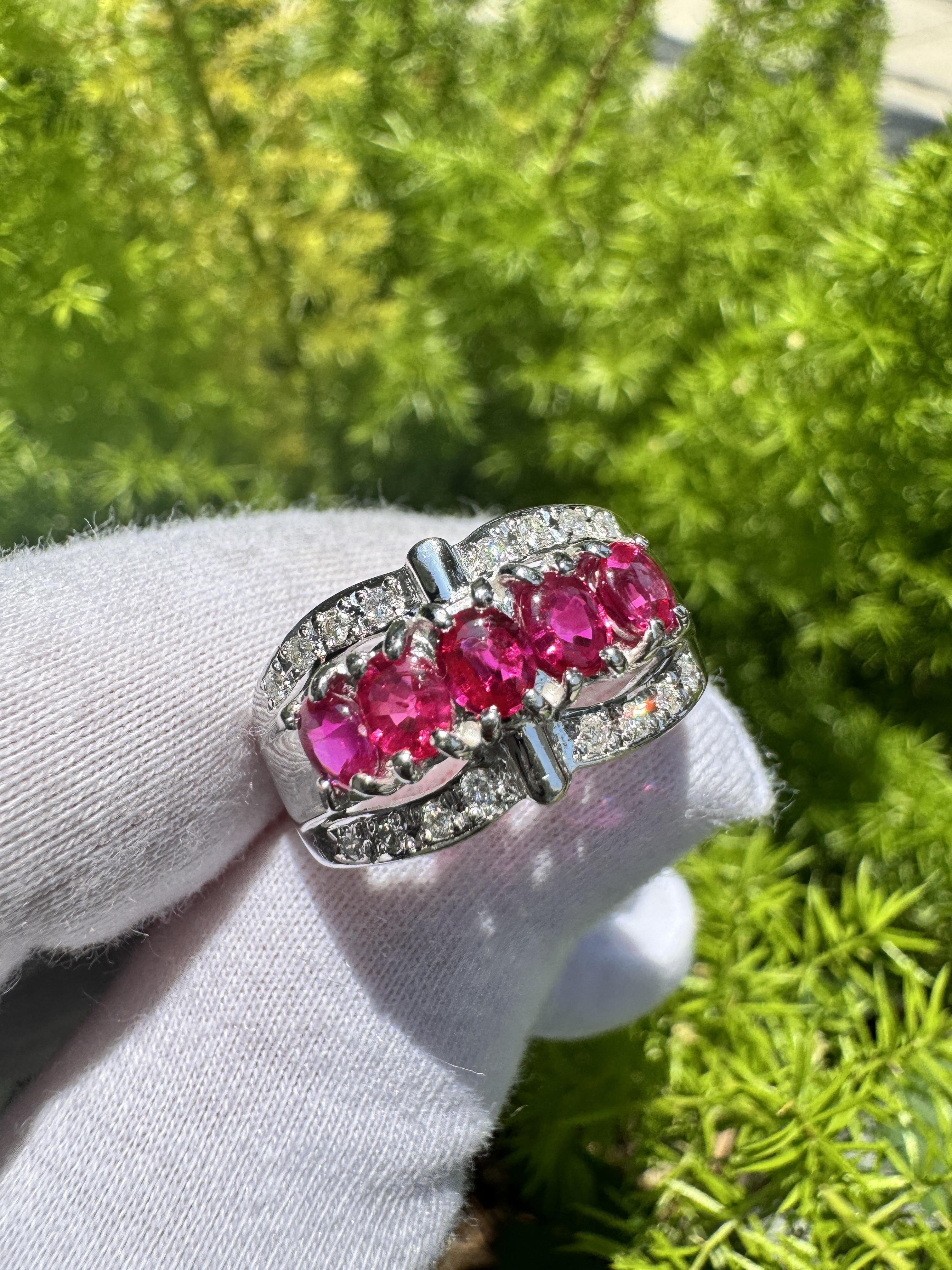 Pinkish Red Ruby and Diamond Platinum Dome Ring. 

This dome shank ring is set in a platinum-crafted ring setting. The ring features five oval-cut rubies. The rubies radiate a pinkish-red hue and have a carat weight of 1.43 total. The rubies are