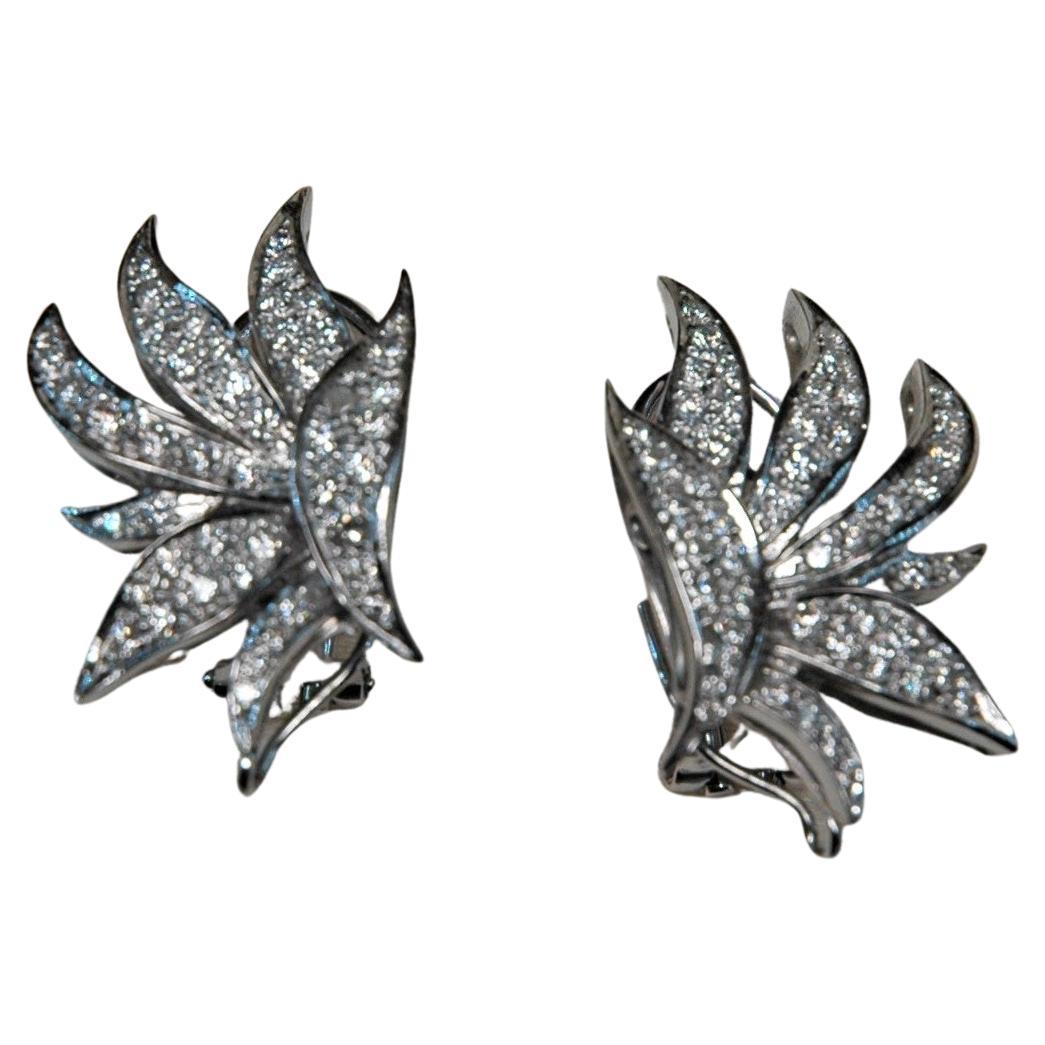These earrings are handmade in Italy, their shape is like a group of leaves. All over the top, there are diamonds. You can wear them also with a pendant, for example with a pearl. In the images, you can see how they look with or without a pendant.
