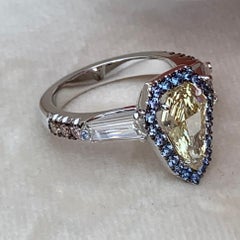 1.43 Carat VVS2 GIA Fancy Yellow Shield Cut Diamond, Unheated Blue Sapphire Ring