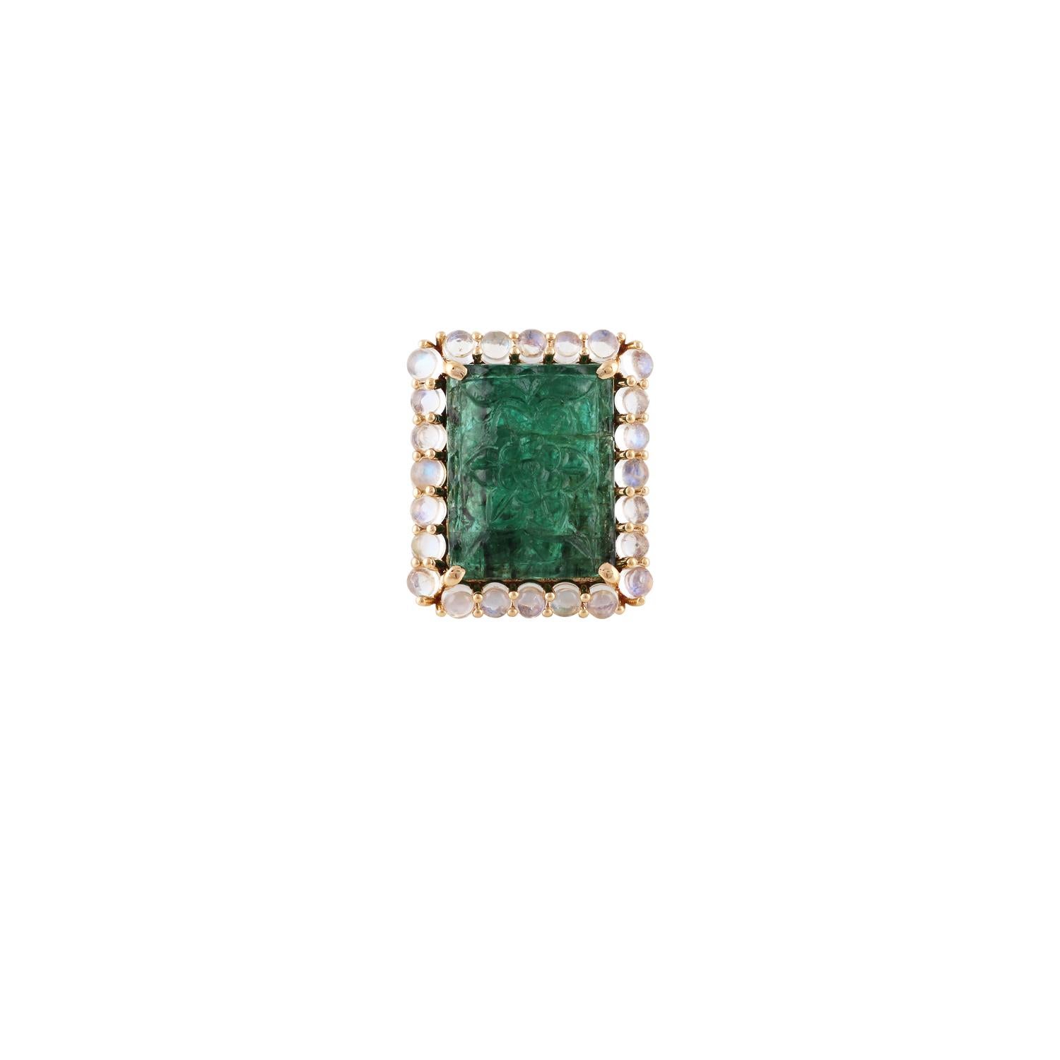 This is an elegant carved emerald & moon stone cocktail ring studded in 18k yellow gold features 1 piece of fine quality carved emerald weight 14.31 carat with 24 pieces of cabochon shaped moon stones weight 3.21 carat, on the emerald there is fine