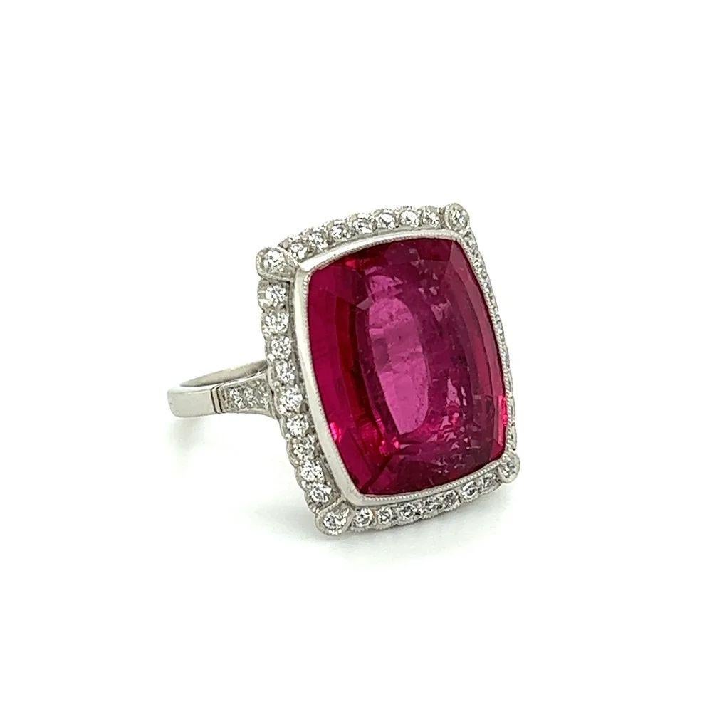 Simply Beautiful Vintage Rubellite Tourmaline and Diamond Platinum Cocktail Ring. Centering a securely nestled 14.31 Carat Cushion Rubellite, surrounded by 42 Old European Cut Diamonds, approx. 0.52tcw and shank accented on either side. The ring is