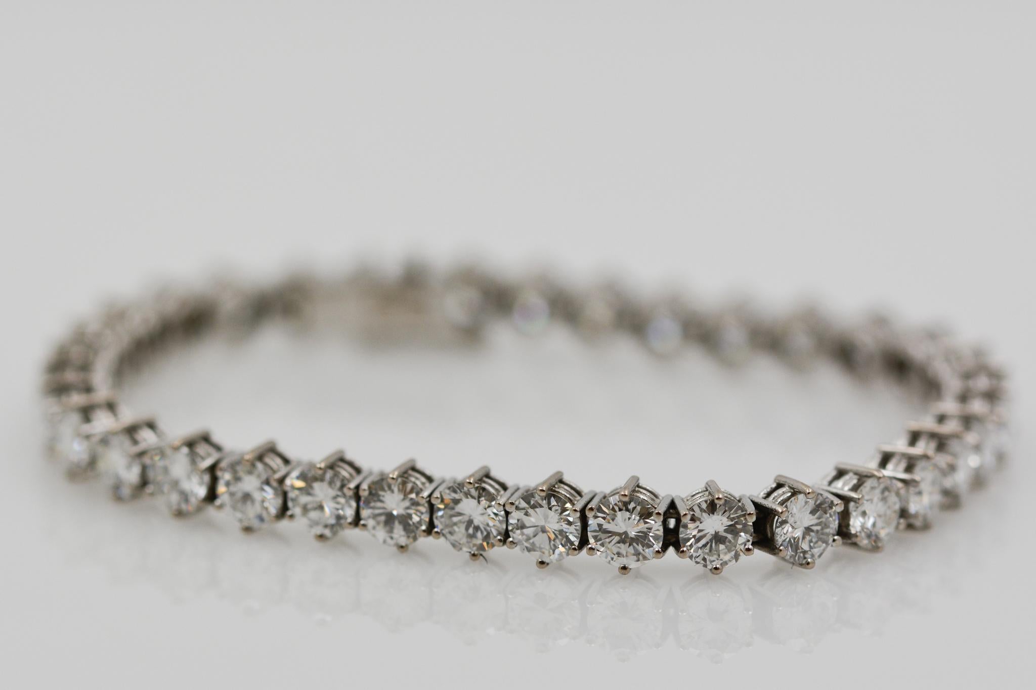 Exclusively from the Eiseman Estate Jewelry Collection, this platinum line bracelet features 35 round brilliant cut diamonds (14.35ctw H-I SI) and measures 7” long. 