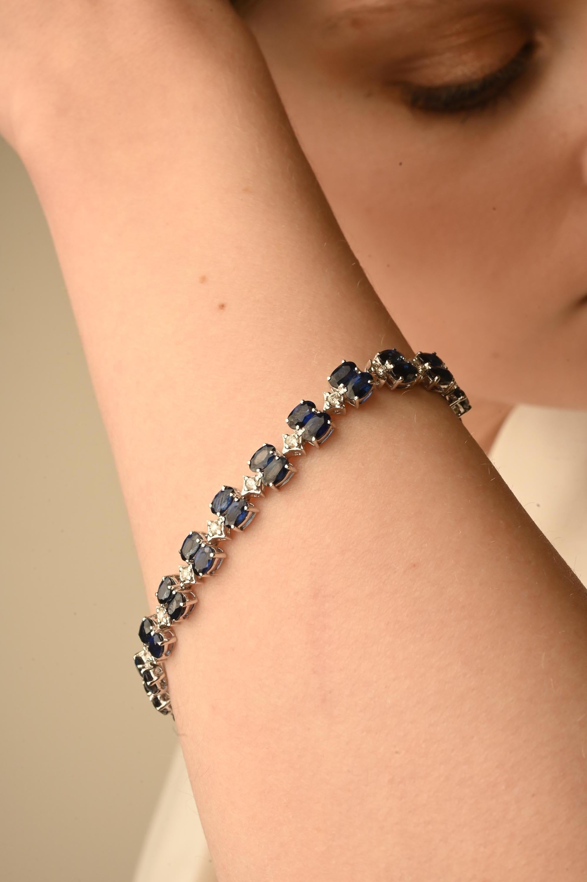 This Blue Sapphire Diamond Tennis Bracelet in 14K gold showcases 44 endlessly sparkling natural sapphires, weighing 14.37 carat and 22 pieces of diamonds weighing 0.56 carat. It measures 7.5 inches long in length. 
Sapphire stimulates concentration