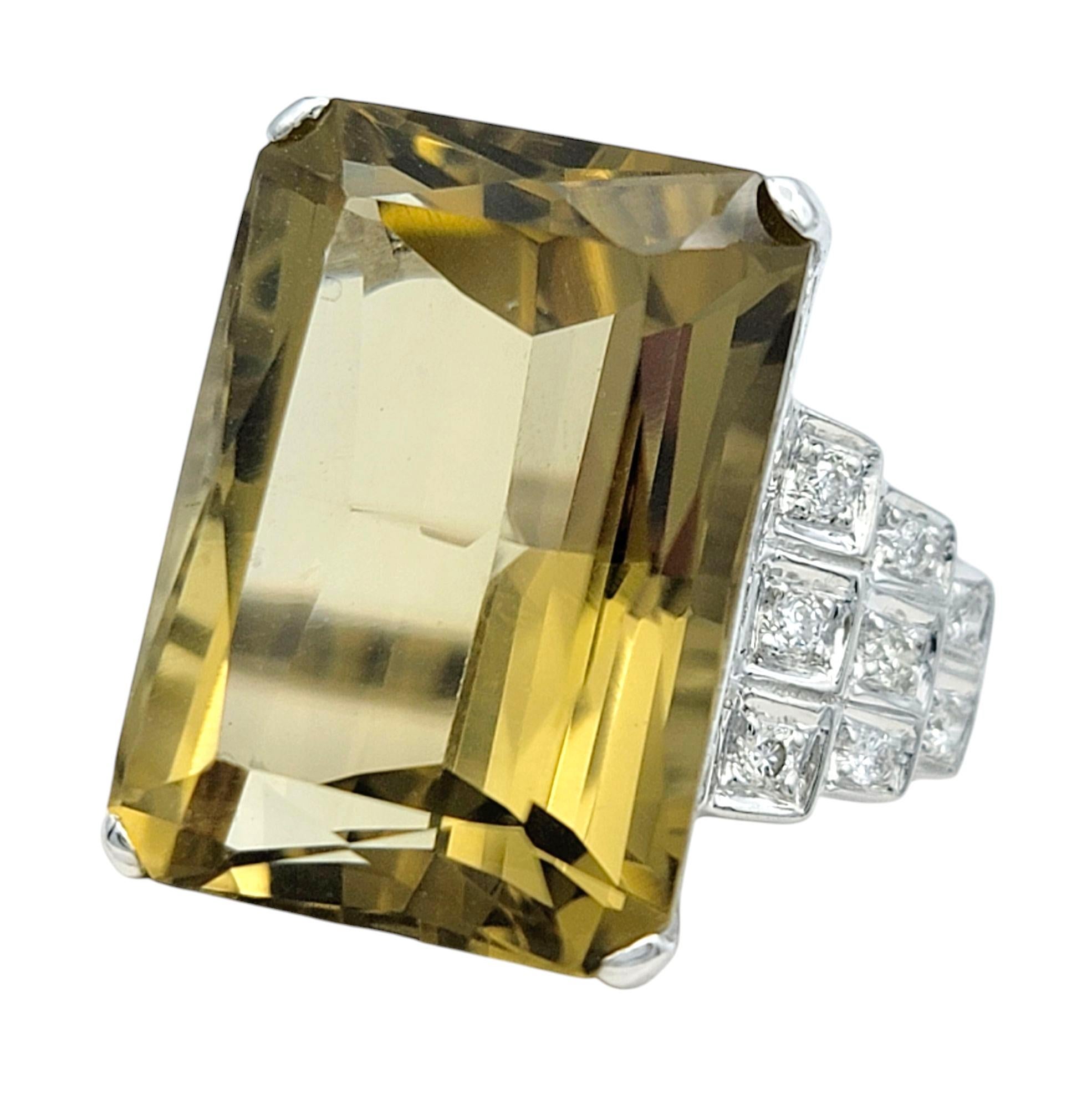 Ring Size: 6.75
 
This exquisite ring features a mesmerizing emerald-cut citrine, radiating a deep, rich hue that captivates with its brilliance. Set in luxurious 18 karat white gold, the striking gemstone is elegantly framed by shimmering diamond