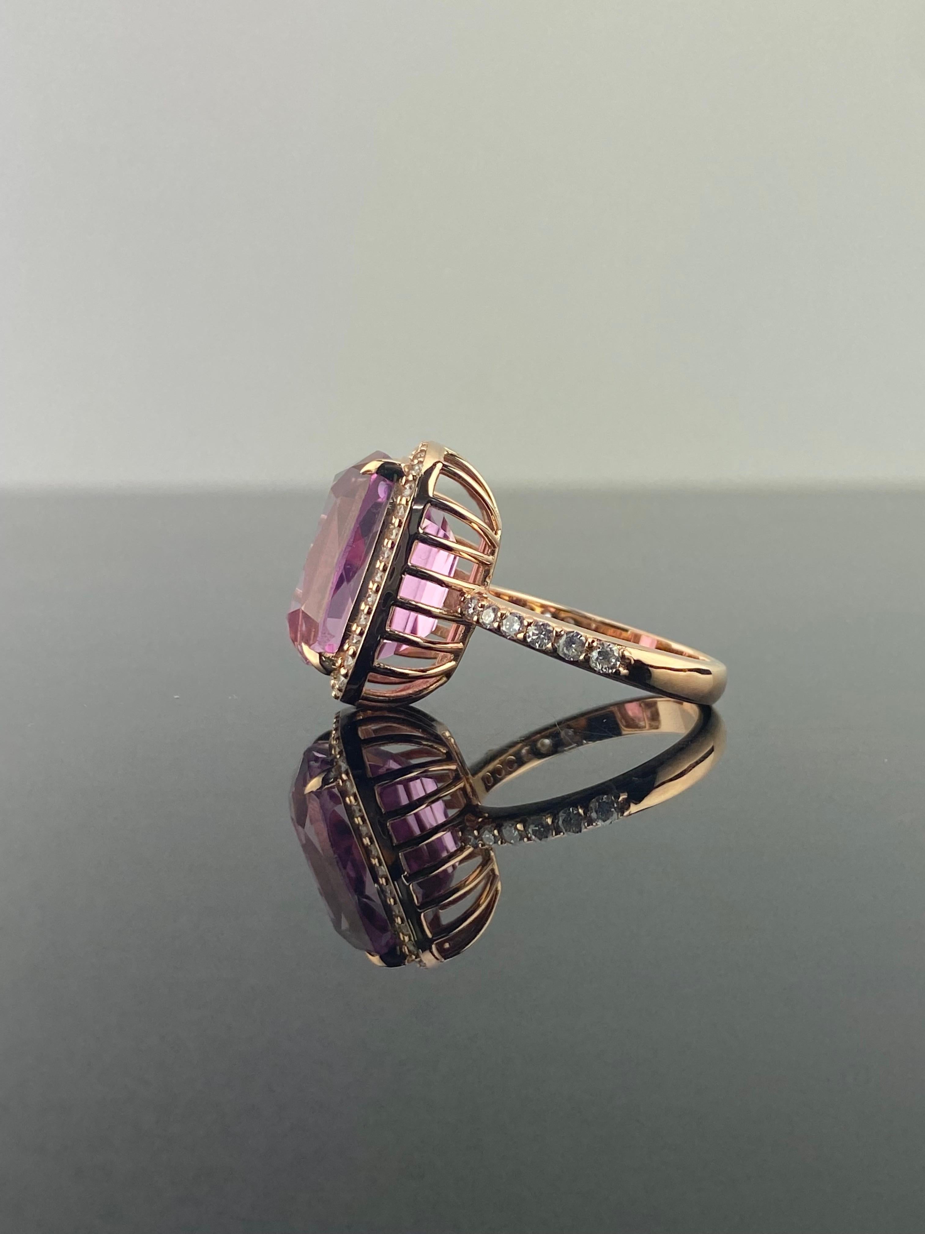 A stunning, 14.38 carat cushion-shaped Kunzite center stone cocktail engagement ring, with 0.55 carat White Diamonds surrounding it, all set in solid 18K Rose-Gold. The Kunzite is transparent, with a beautiful eye-catching purplish-pink color, and