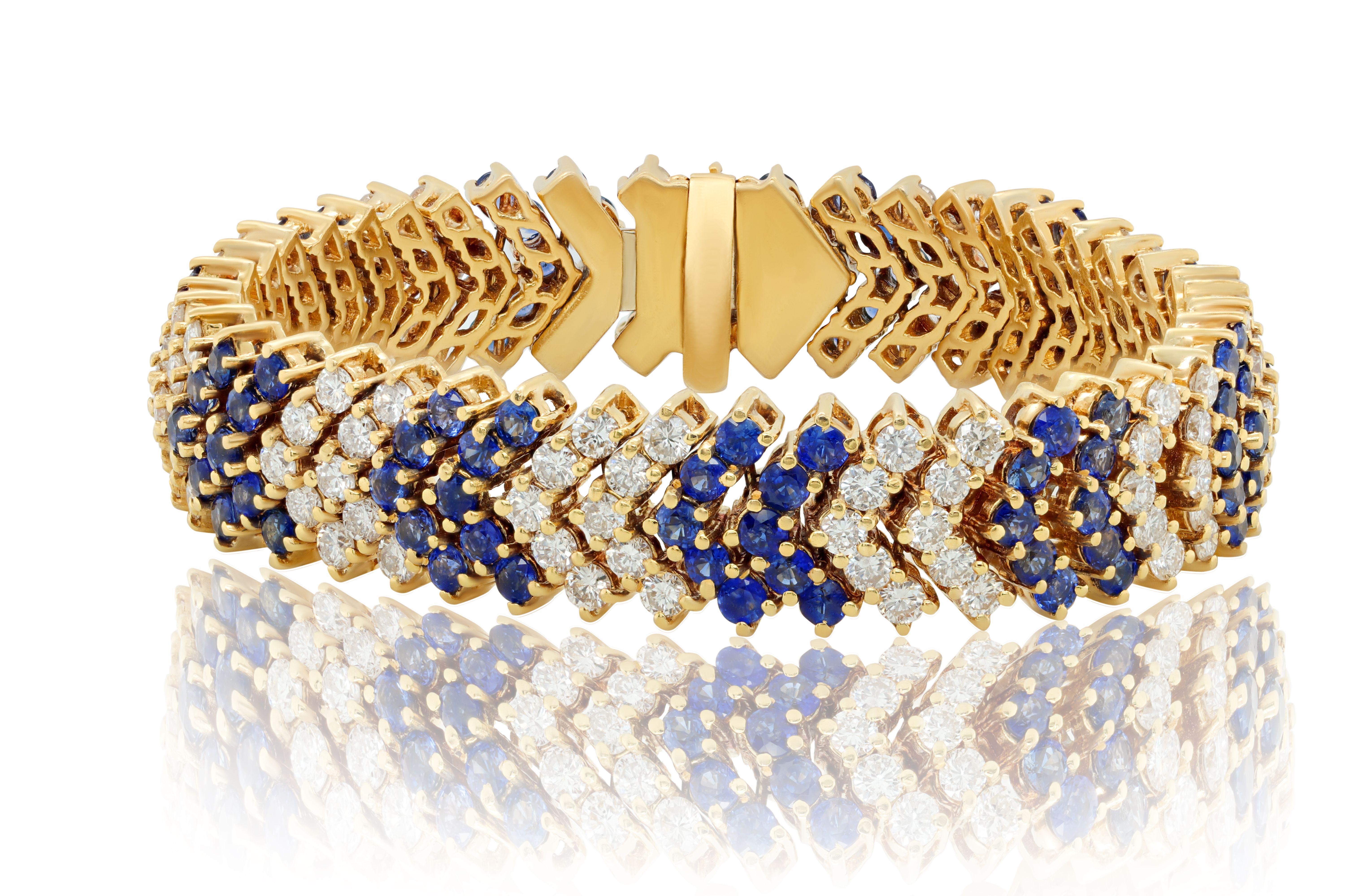 18 kt yellow gold diamond and sapphire bracelet with V-shaped pieces adorned with 14.39 cts tw of blue sapphires and 10.02 cts tw of white diamonds alternating between 2 sapphires and 2 diamonds 