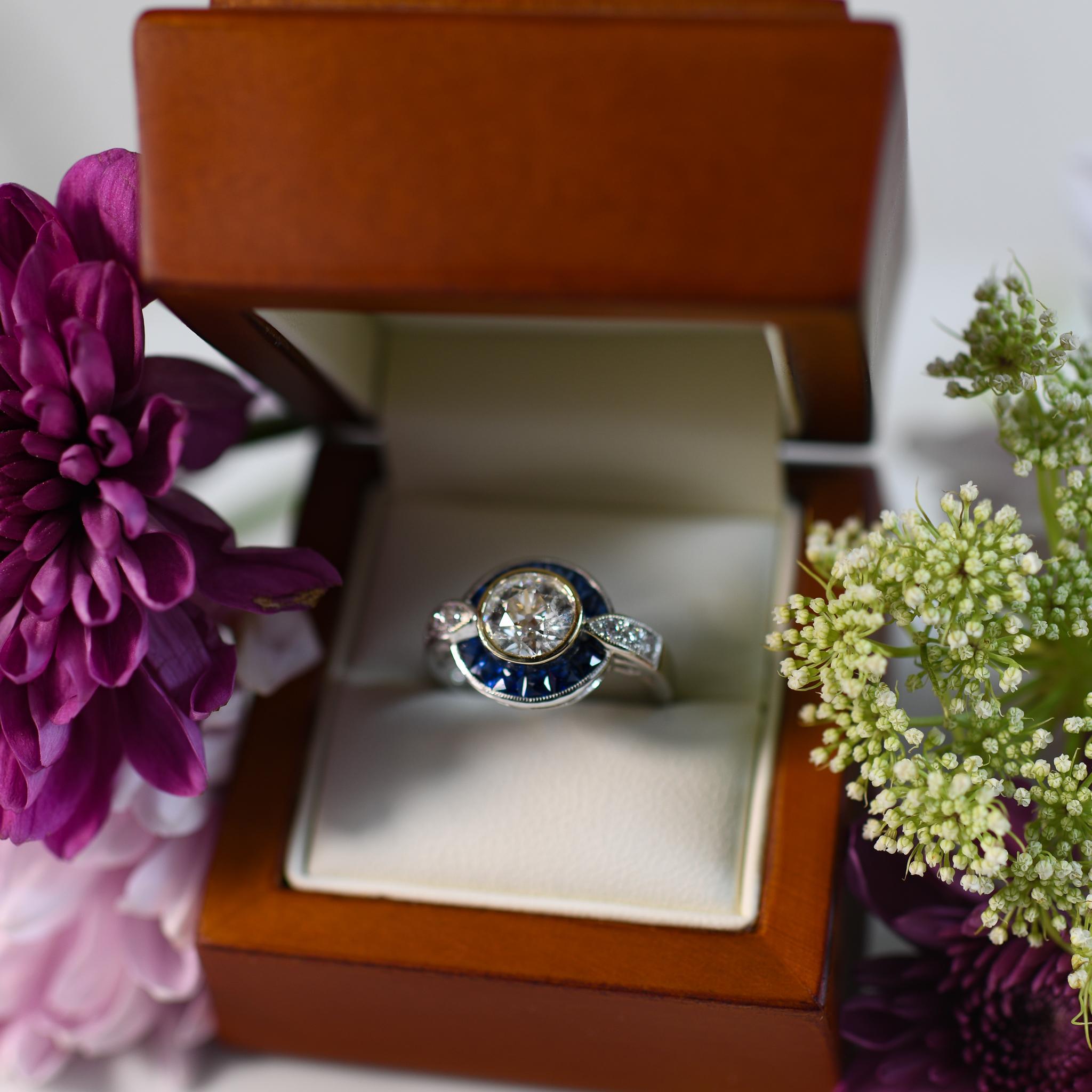 Elegance meets opulence in this stunning 18K white gold diamond sapphire halo ring, exuding timeless sophistication. The lustrous white gold setting accentuates the brilliance of the carefully selected diamonds, while a radiant yellow gold bezel