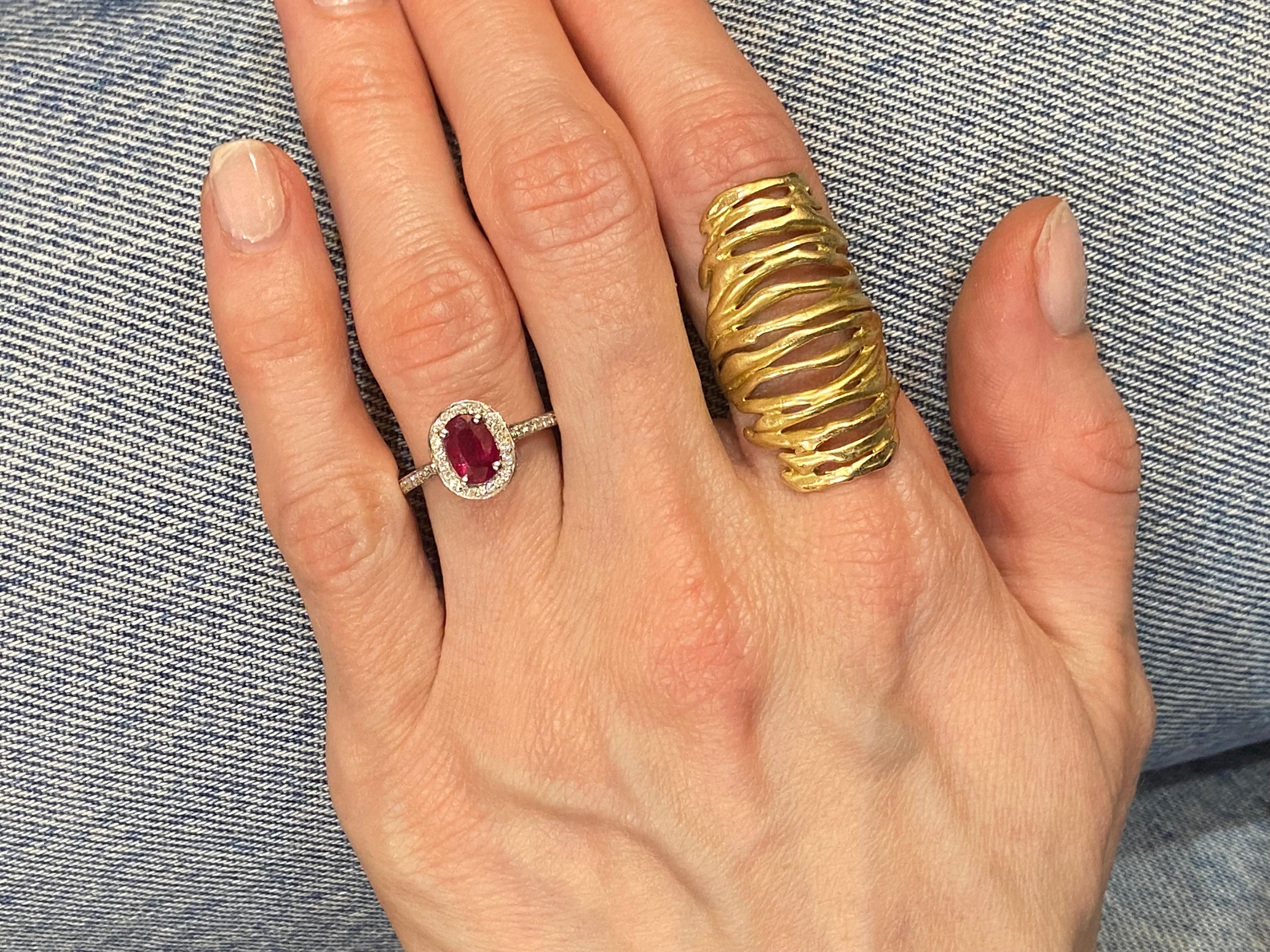 18KT White Gold
Ring Size: 6.5
(Ring is size 6.5, but sizable upon request)

Number of Oval Rubies: 1
Carat Weight: 1.02ctw
Stone Size: 7.0 x 4.85mm

Number of Round Diamonds: 89
Carat Weight: 0.41ctw