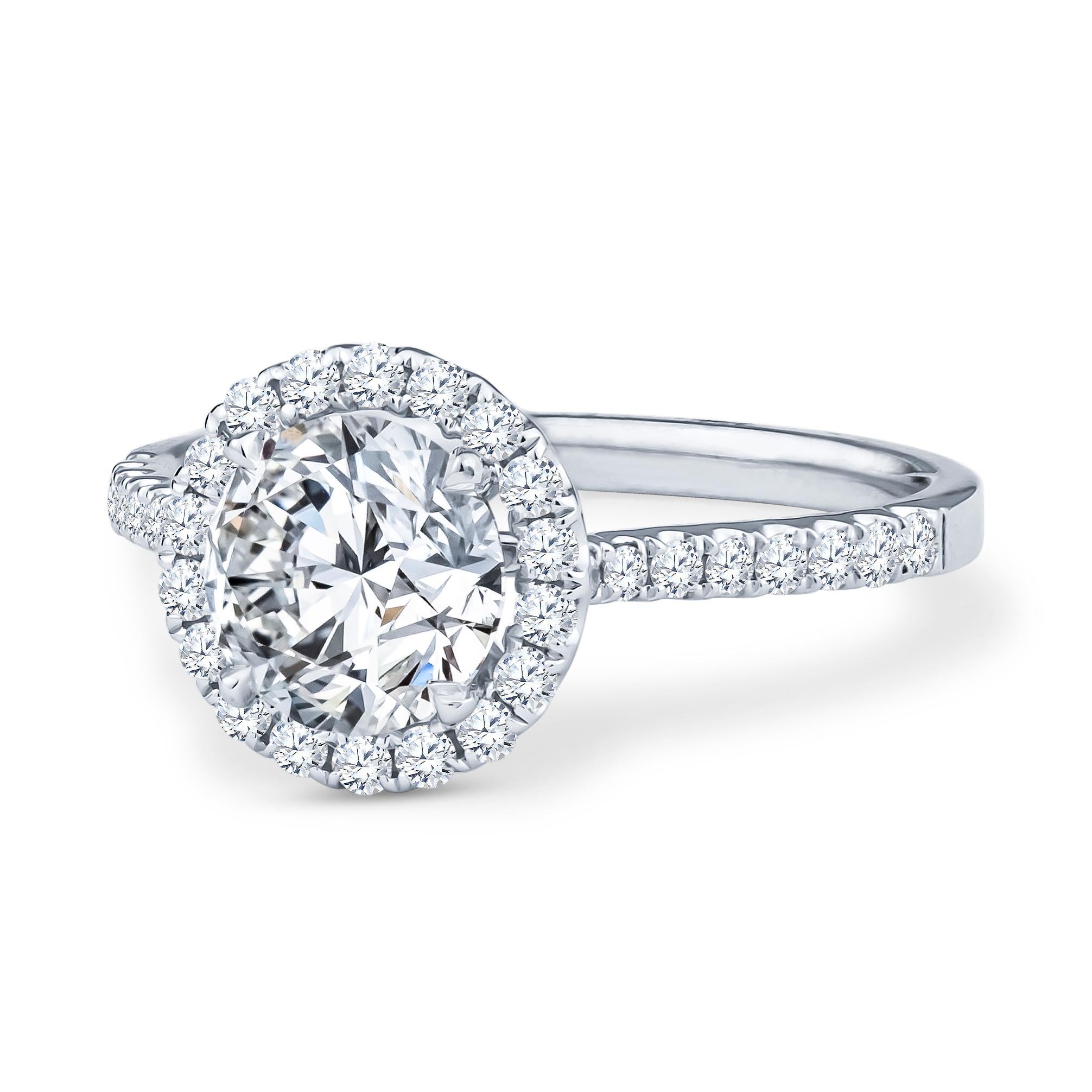 This beautiful engagement ring has a 1.43ct round brilliant cut center diamond, I SI1 (GIA 7291485021, inscribed) is set in an 18kt white gold round halo cathedral style ring. It has a semi mount with 34 round brilliant cut diamonds with a total