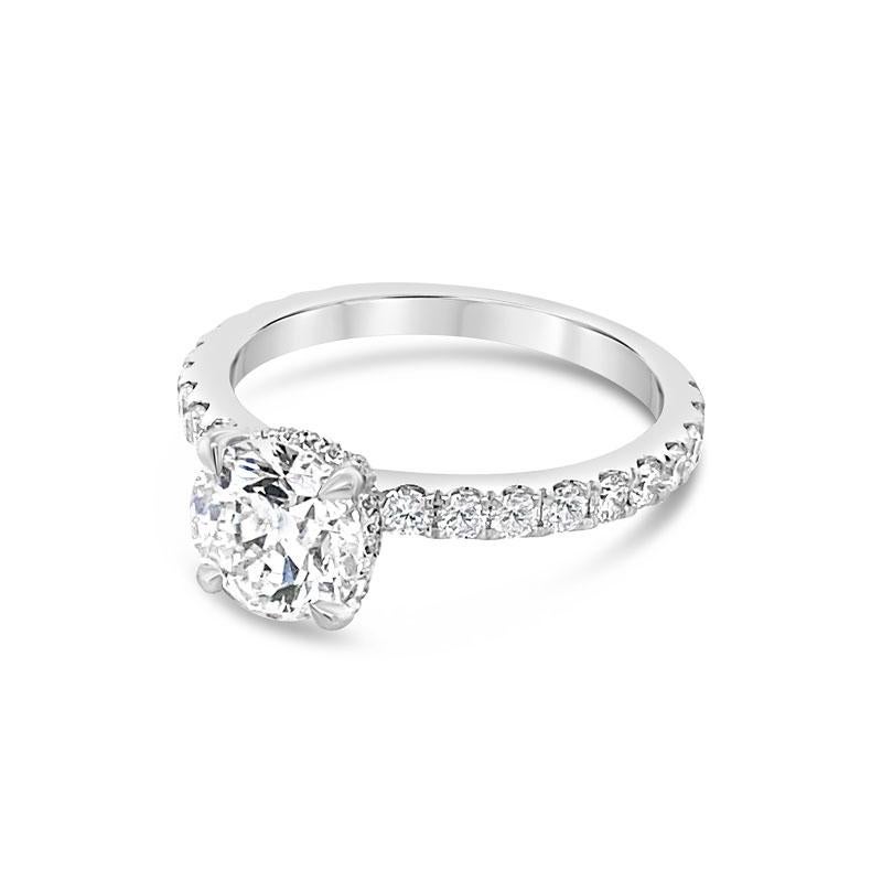 An 18 karat white gold engagement ring featuring a 1.43 carat round brilliant cut diamond, I SI1, accented by diamonds that go halfway down the band and diamonds on the head. It is currently a size 6.5 but can be resized upon request. 
Measurements: