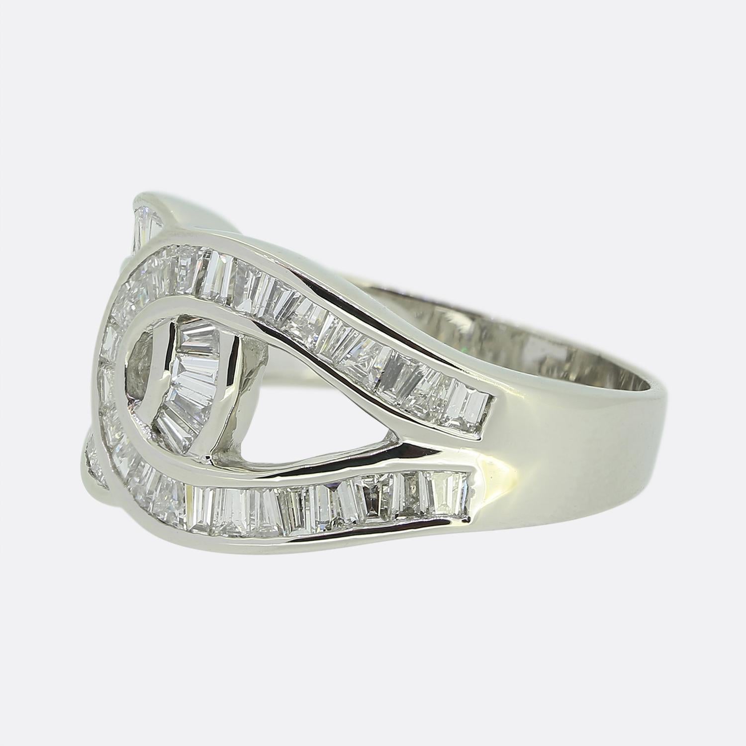 This is a platinum and diamond crossover ring. The ring is set with 48 tapered baguette cut channel set diamonds The ring features 4 layers of stunning, invisibly set, baguette cut diamonds. In order to cater for the curve of the ring some of the