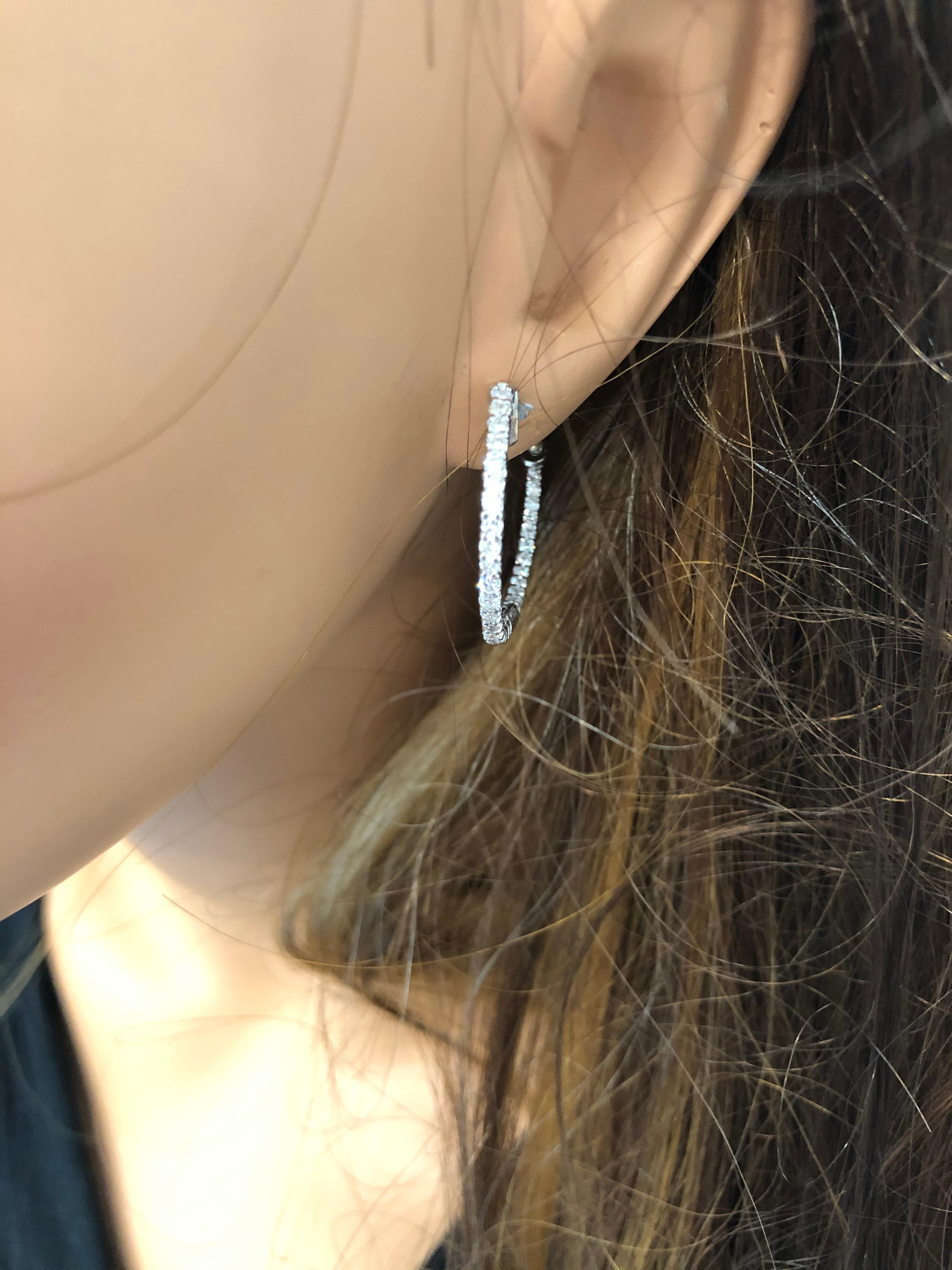 Designed in brightly polished 14 karat white gold, this gorgeous pair of inside out trellis pattern hoop earrings are the perfect fine jewelry accessory to treasure for a lifetime. These spectacular hoops feature 72 sparkling round brilliant cut
