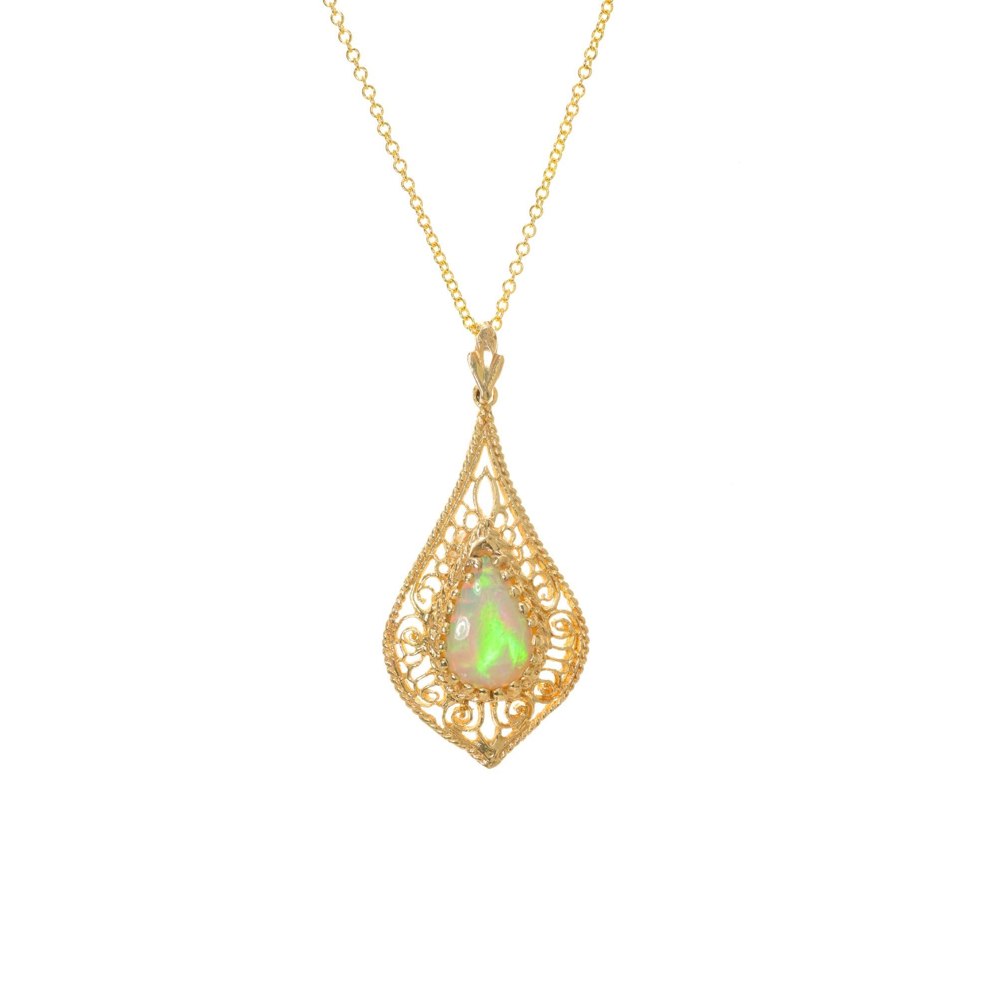 1960's Bight orange green opal filagree pendant necklace. Pear shaped 1.44ct opal set in a exquisitely finely detailed filigree setting.  With an 18 Inch 14k yellow gold chain. 
Follow us on our 1stdibs storefront to view our weekly new additions