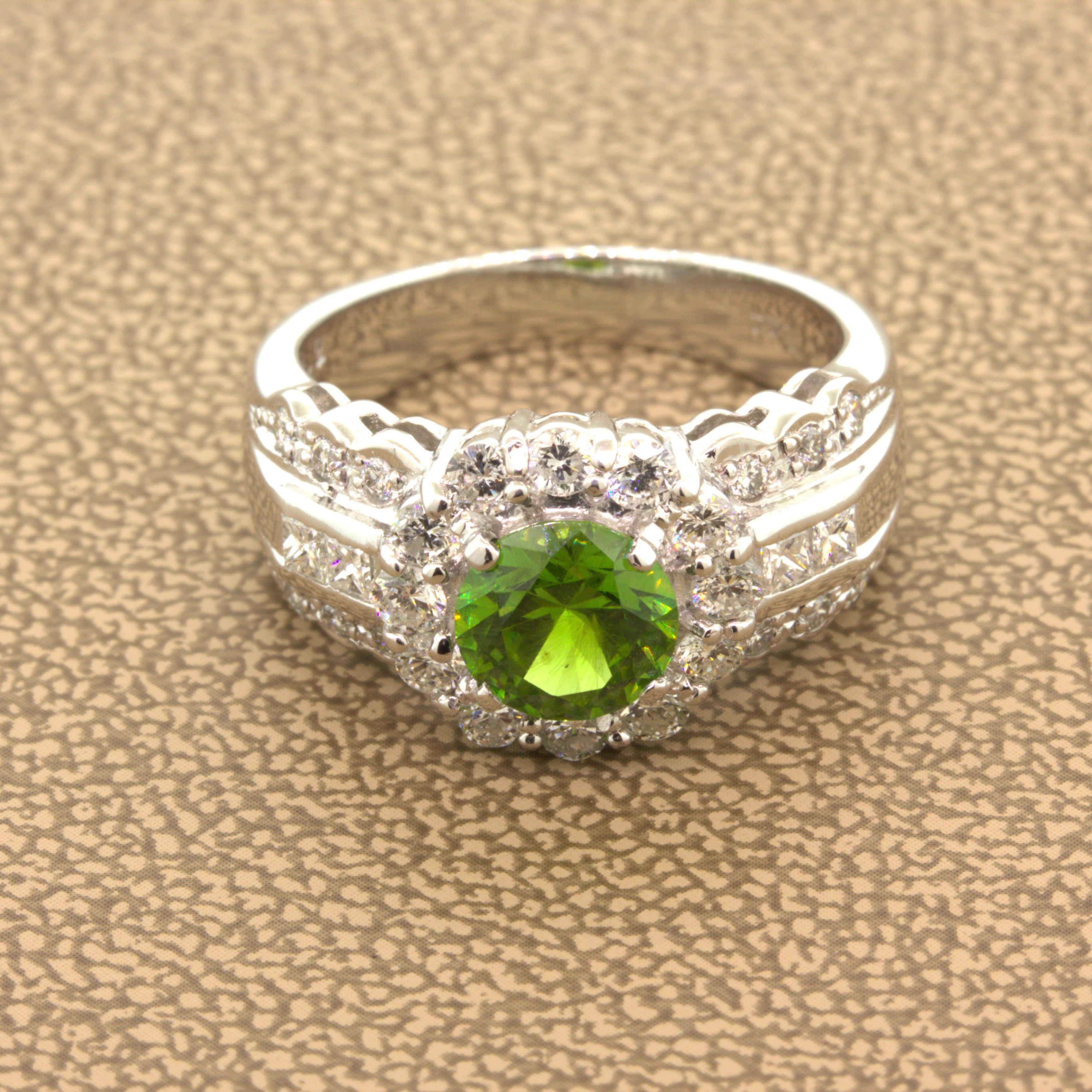 A very rare and beautiful natural gemstone takes center stage. It is a vibrant demantoid garnet from the Ural Mountains in Russia. It weighs 1.44 carats which is very large for stones like this with strong bright green color and immense brilliance