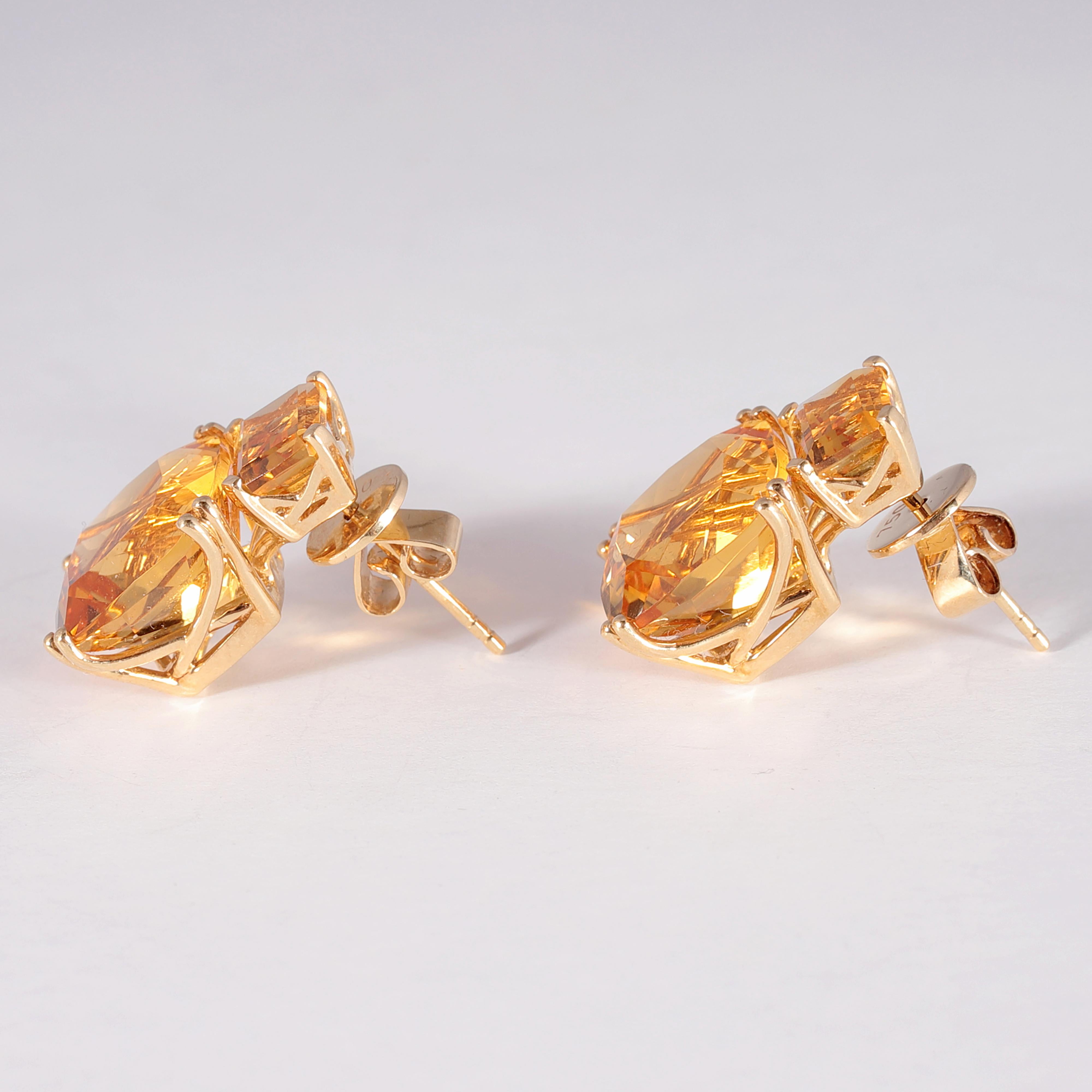 Such a great pop of color!  These bright citrine and 18 karat yellow gold earrings are secured with a pierced back and have a total weight of 14.40 carats. 