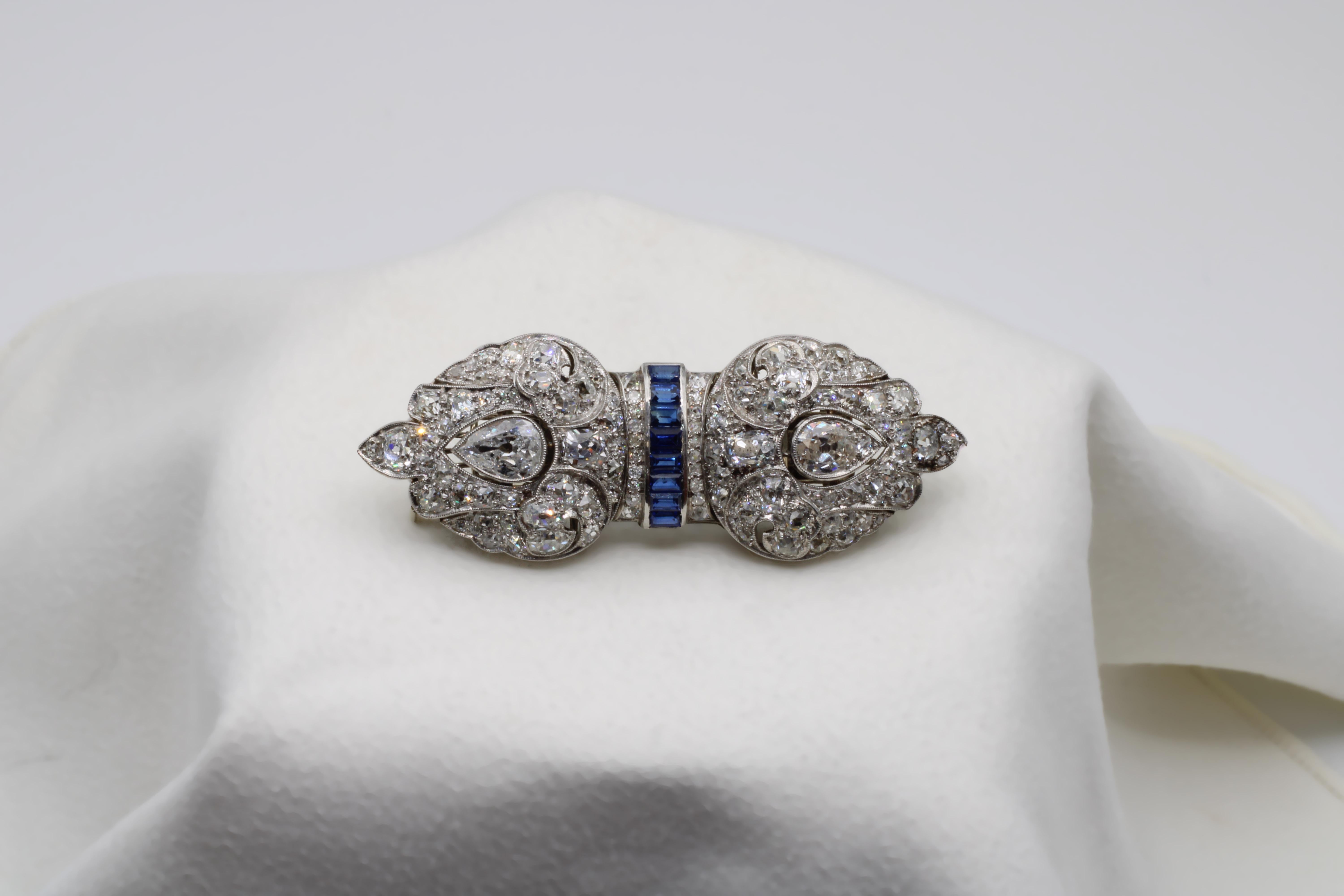 A surreal piece drenched in 14.40 carats of Old European and Old Miner Diamonds restricted to not just one brooch, but two. Featuring over 120 stones, including two 1.20 Old European Pear Cuts, and held together by royal blue sapphires, this piece