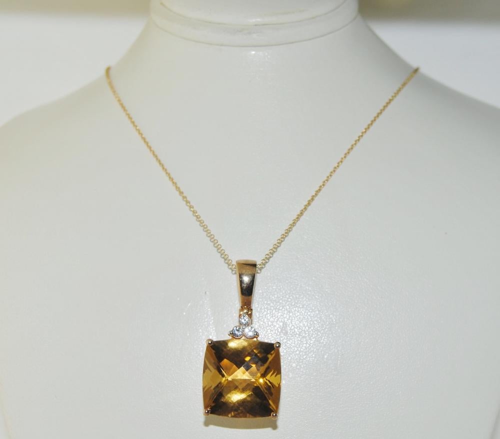 Pendant featuring 14.41 carat cushion checkerboard surface Citrine with 3 white Sapphires 0.23 carat in silver yellow plated.  Pendant length 1.25 inches, width 0.57 inches. 