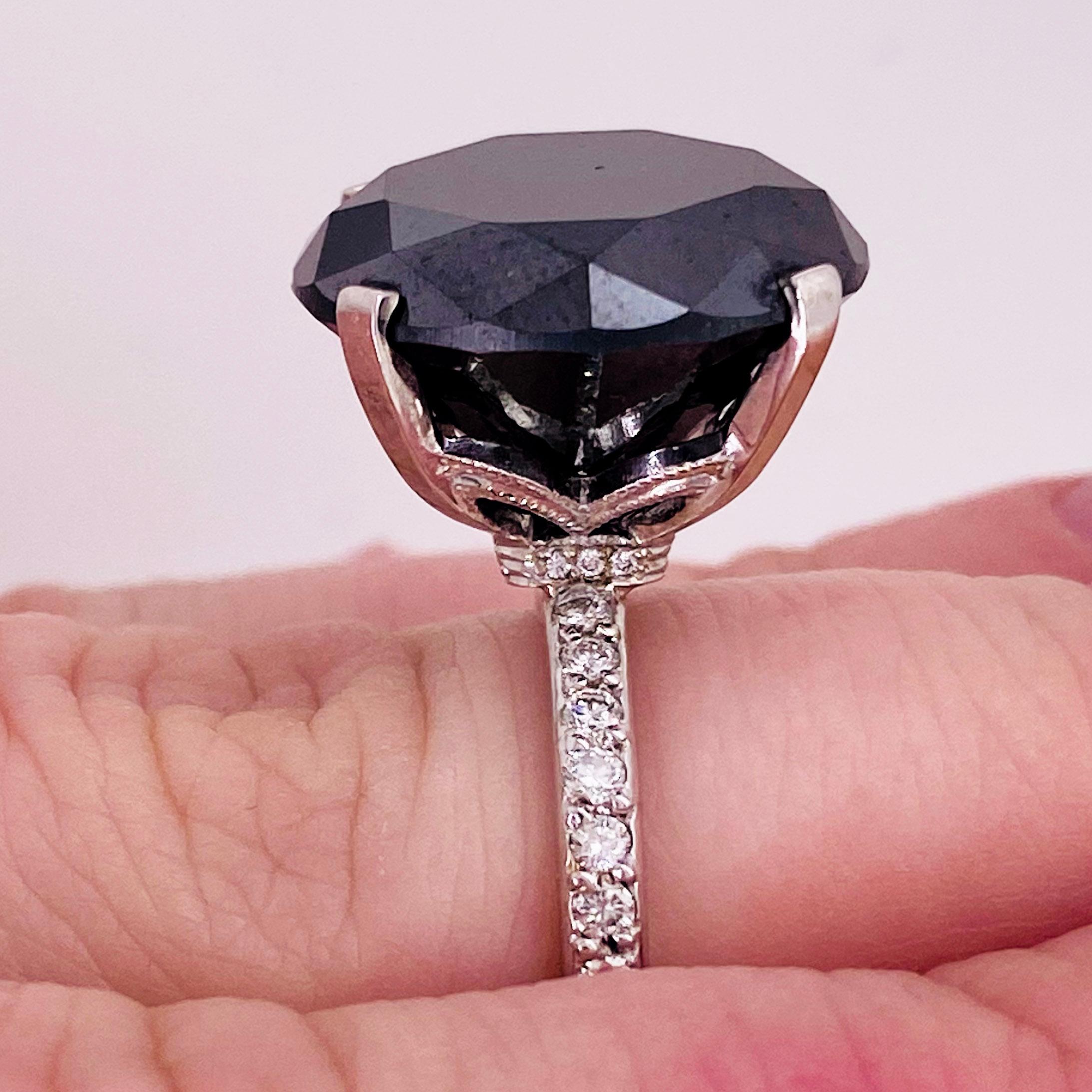 GORGEOUS, STUNNING, BREATHTAKING doesn't begin to describe the 13.96 - carat round black diamond! With great color and size this diamond will look great on anyone! This gorgeous center stone is set in a brilliant 14K white gold setting with a hidden