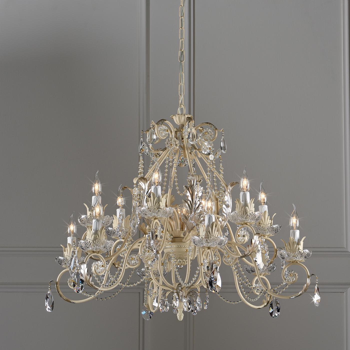 Create a lavish dining experience with this exquisitely detailed chandelier. Made entirely by hand, the chandelier boasts an ivory finish with silver leaf detailing. With twelve arms, the chandelier drips with crystal pendants and glass pearls, for