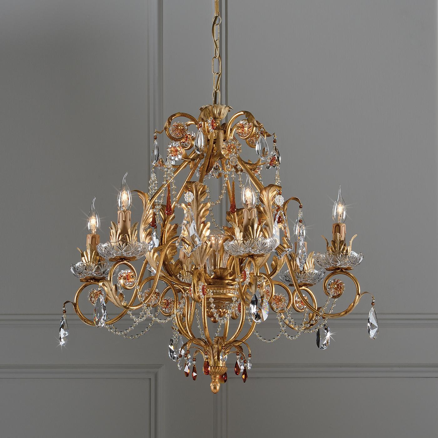 Made by hand, this chandelier is inspired by centuries of Italian style and know-how. Featuring transparent and amber crystals, the chandelier is coated in an aged gold leaf finish, giving it an antique look. Display the chandelier over a dining