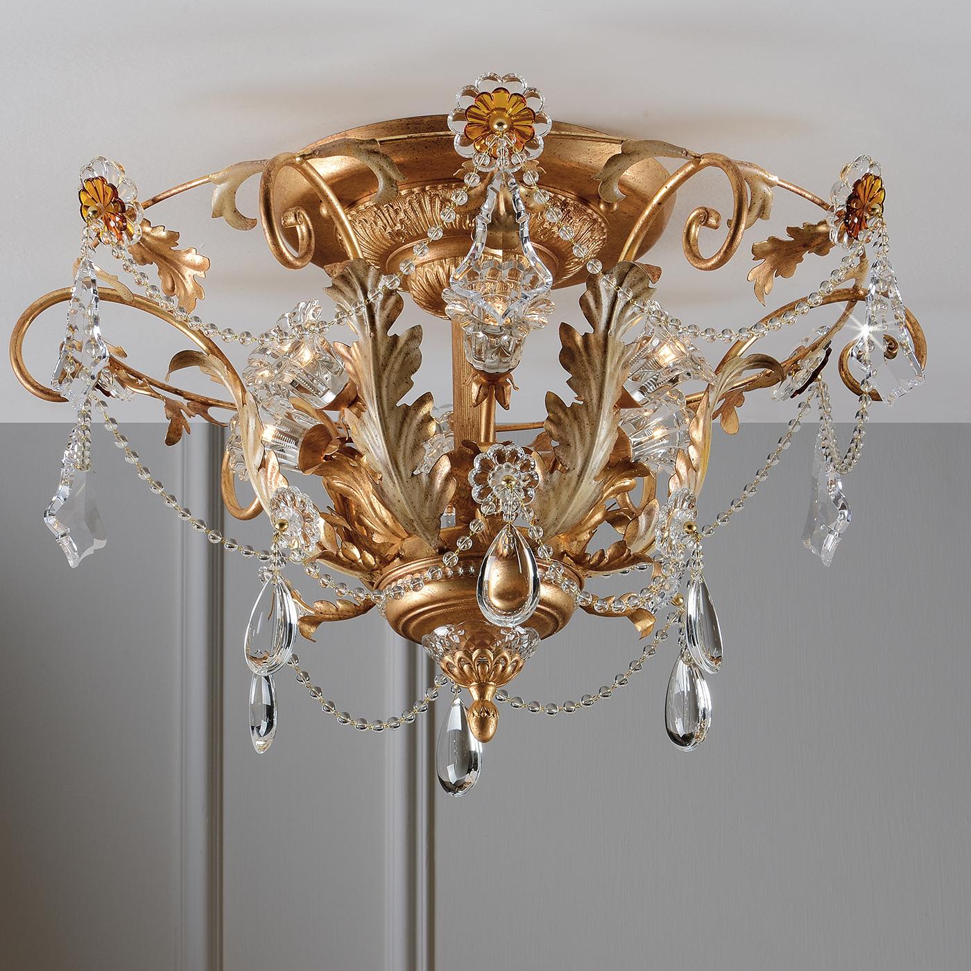 Lend a living space an elegant, traditional feel with this ceiling light. Inspired by centuries of Italian tradition, the ceiling light is coated with an aged gold leaf finish, giving it an antique look. With transparent and amber-colored crystals,