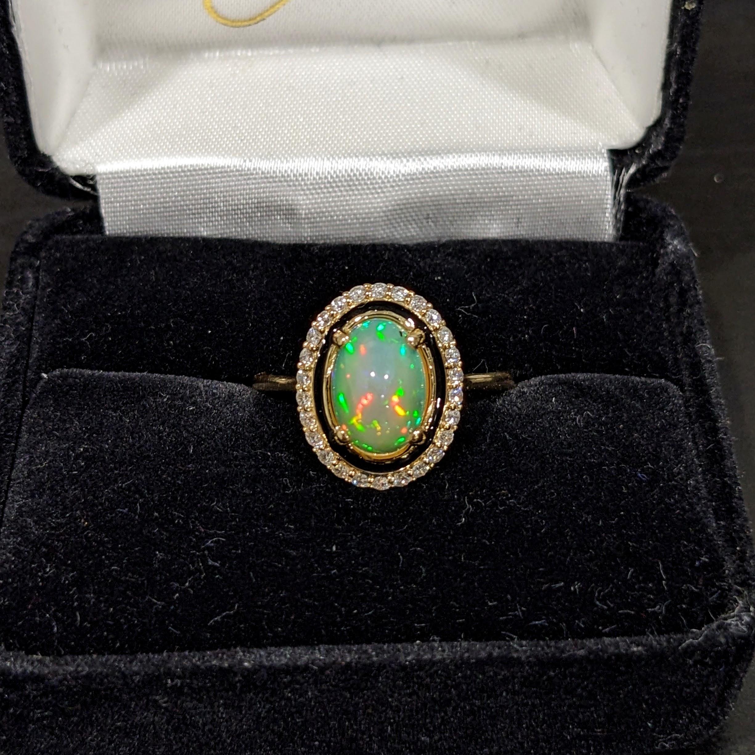 This opal ring exhibits an incredible play of color enhanced by this NNJ Designs original setting design with black enamel and natural diamonds set in 14k Yellow Gold.

Specifications:

Item Type: Ring
Center Stone: Opal
Treatment: None
Weight: