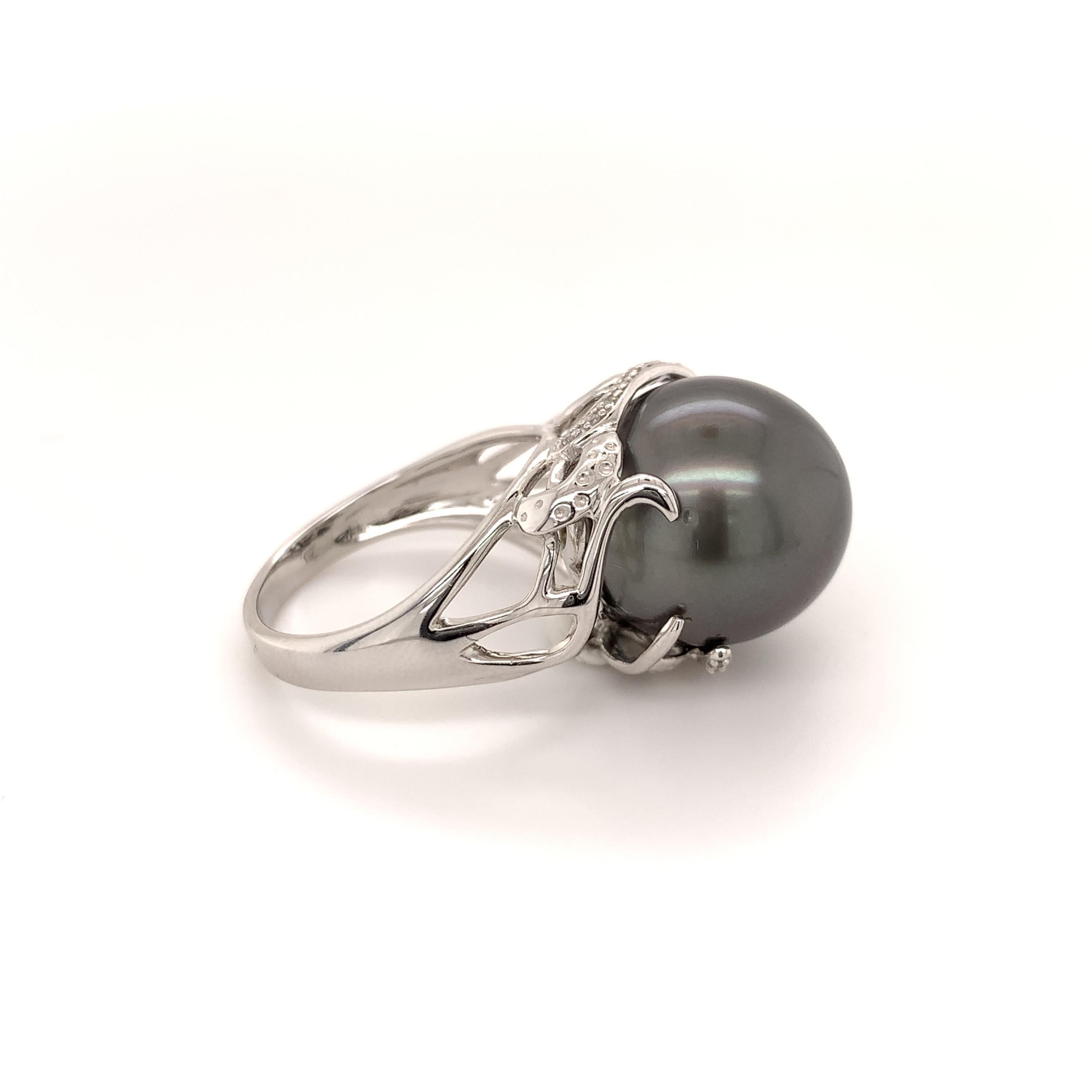 Stunning Tahitian pearl cocktail ring. Good luster, round 14.4mm Tahitian pearl, black with rose' overtone accented with round brilliant cut diamonds. Handcrafted design set in high polished 14 karats white gold.

Pearl: 14.4mm, good luster, round,